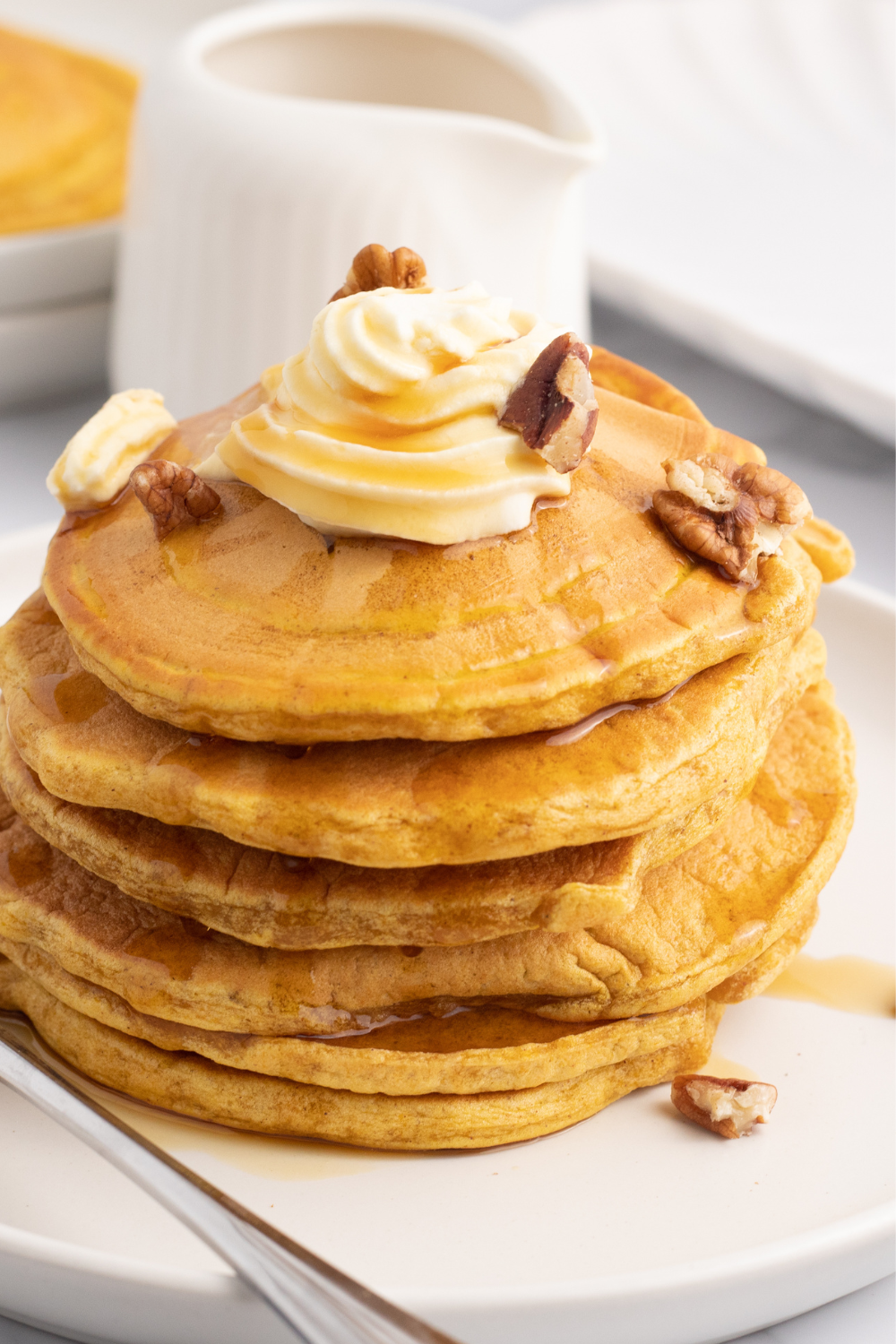 pumpkin pancakes stacked on plate