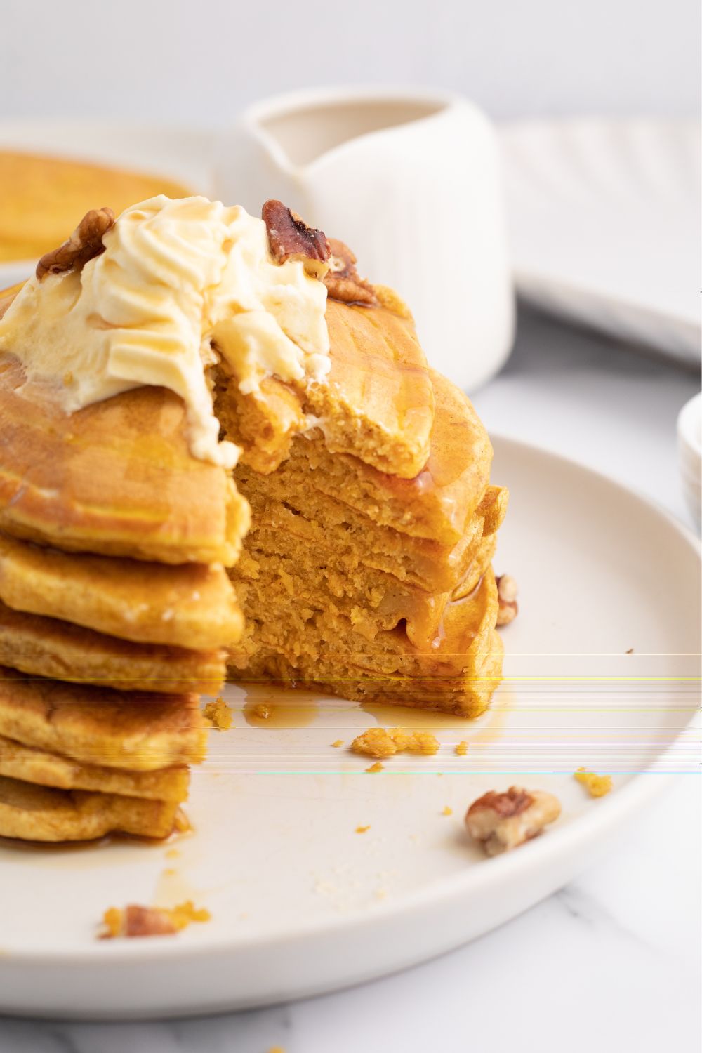 pumpkin pancakes stacked on plate