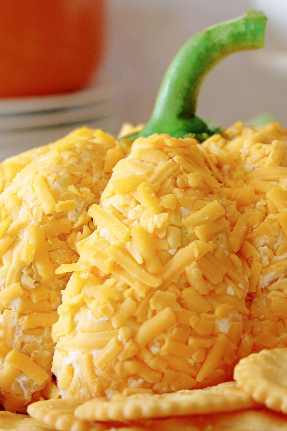 pumpkin shaped cheese ball on a plate