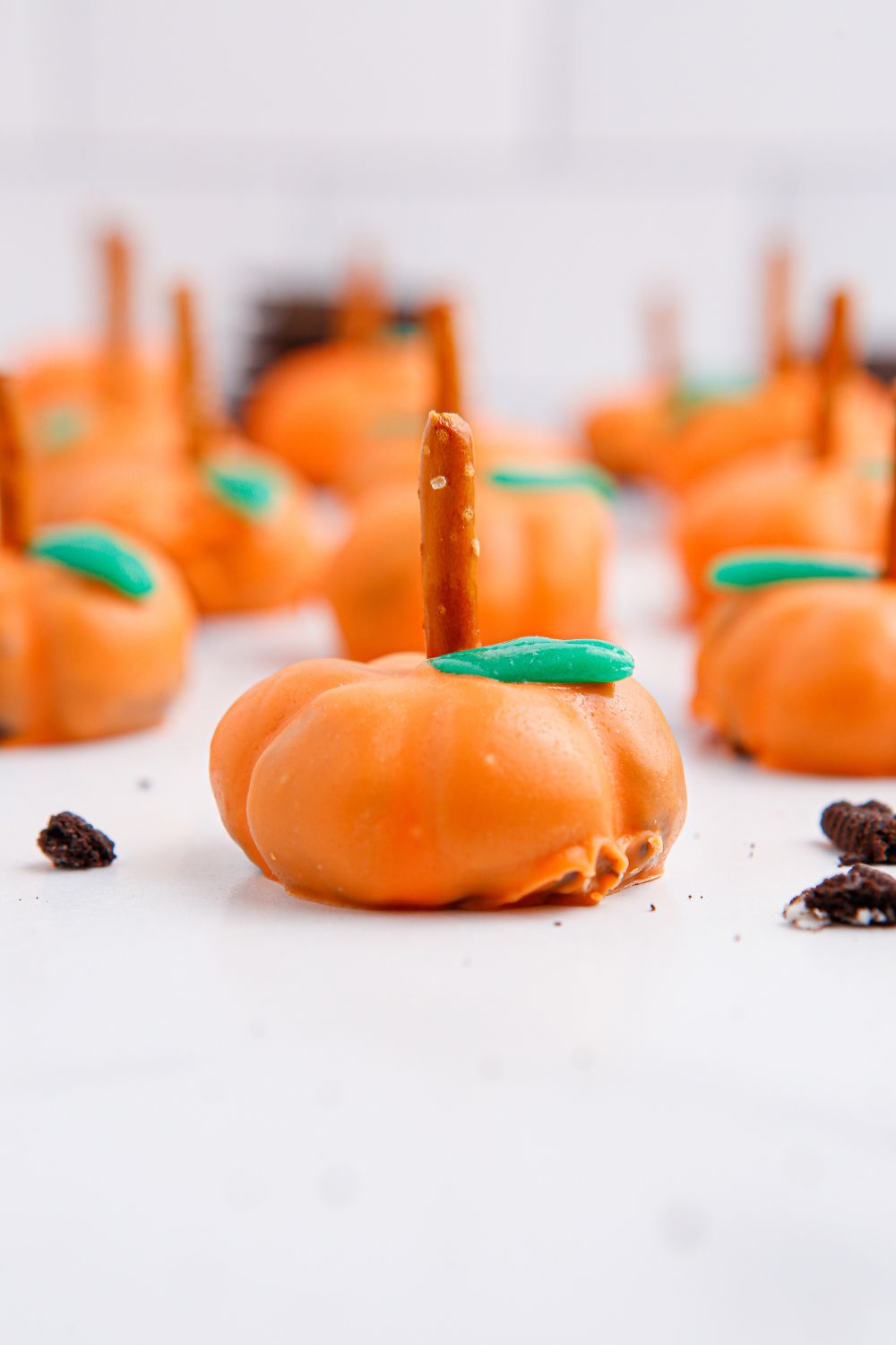 pumpkin shaped oreo treats on white table