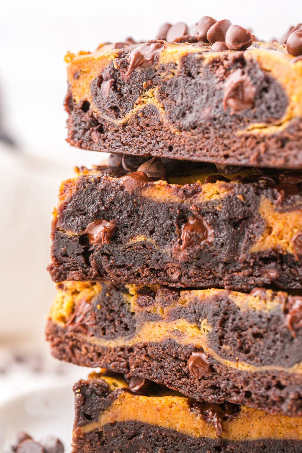 pumpkin swirl brownies stacked on table