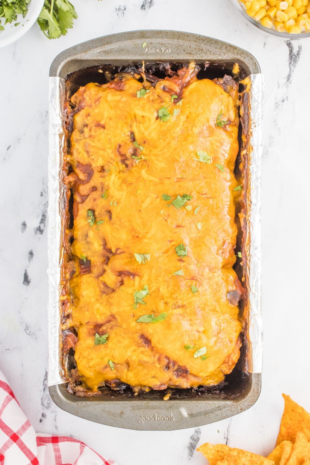 cooked meatloaf in a pan with cheese on top