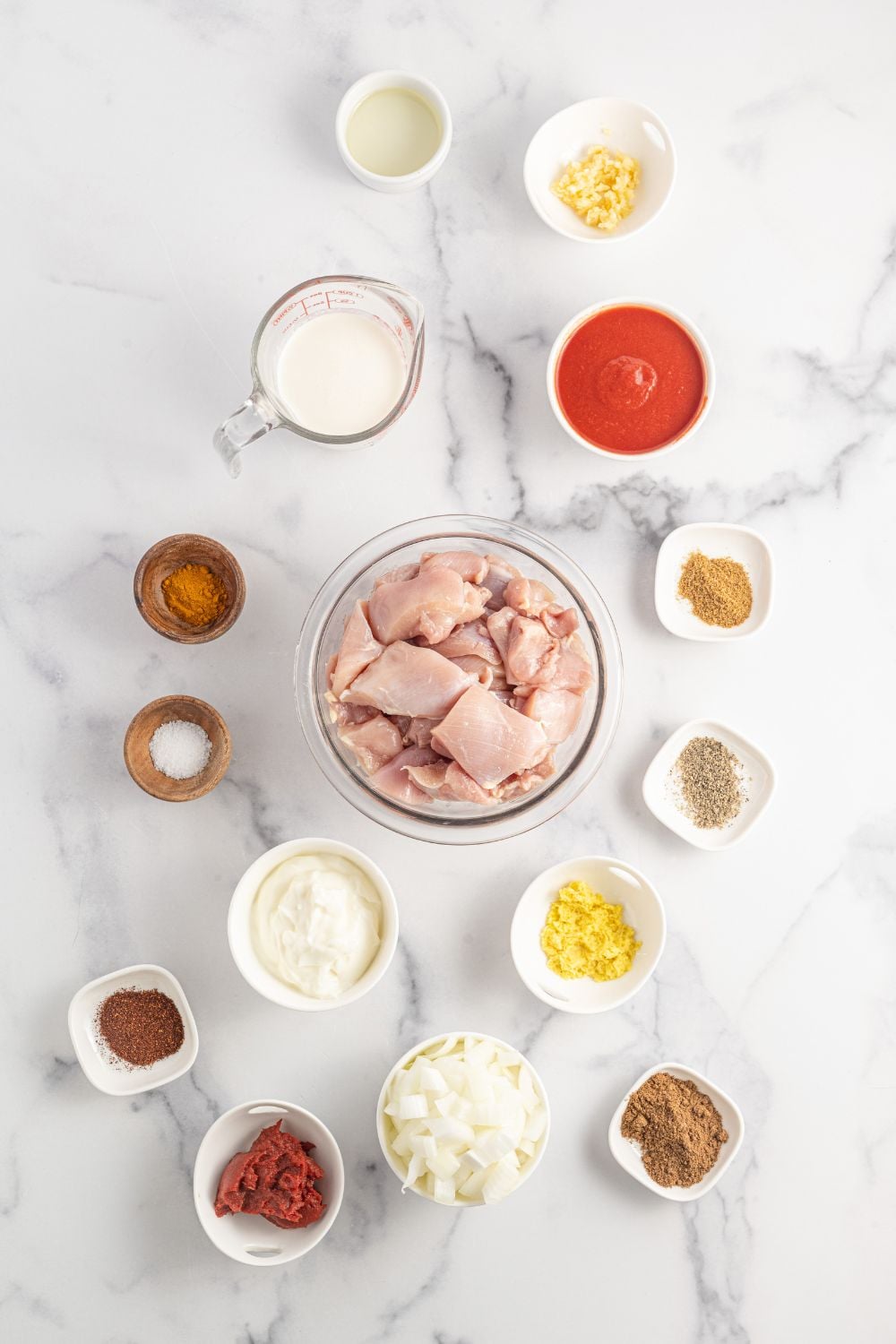 slow cooker tikka masala ingredients in glass bowls on table