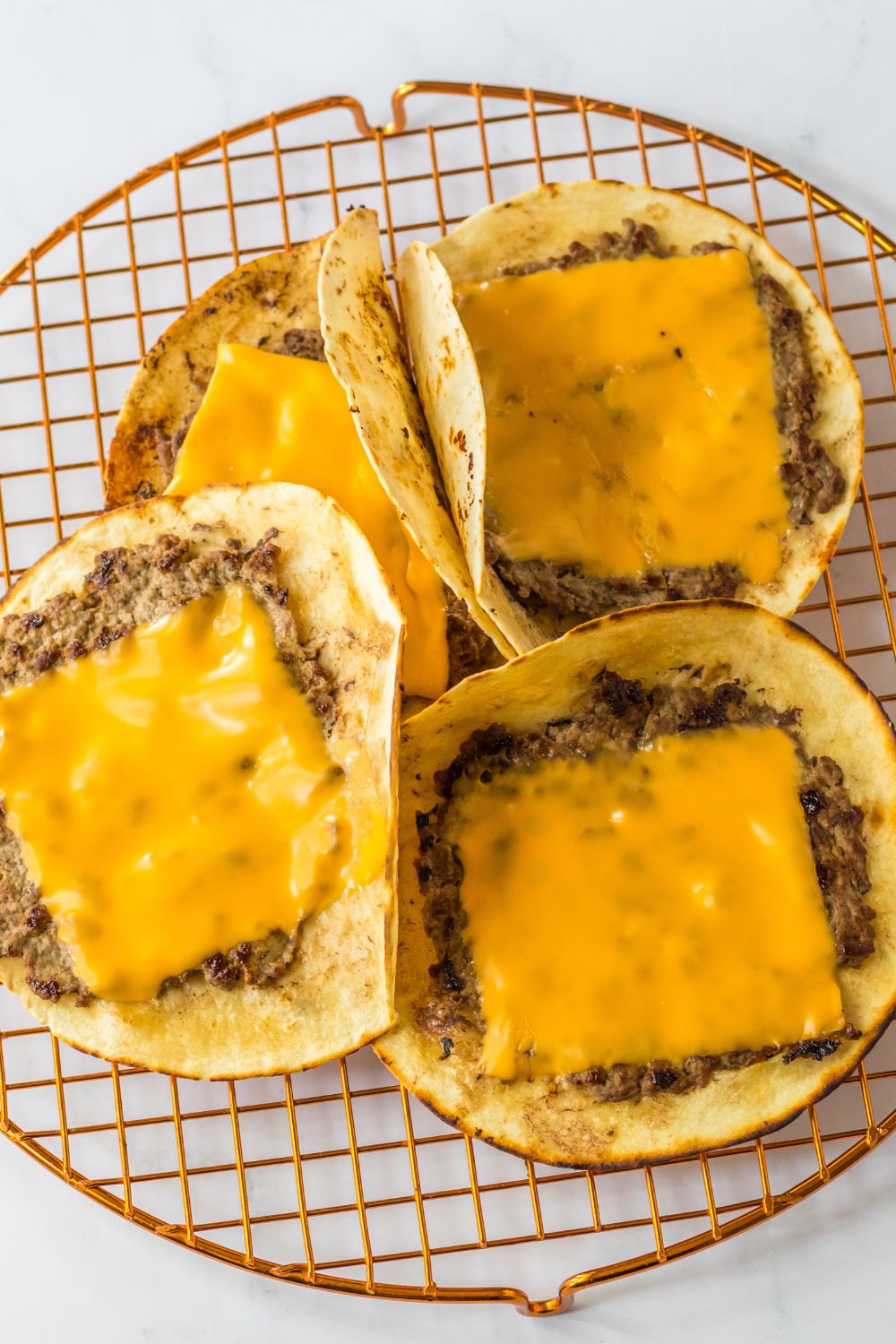 smash taco burgers with cheese on top