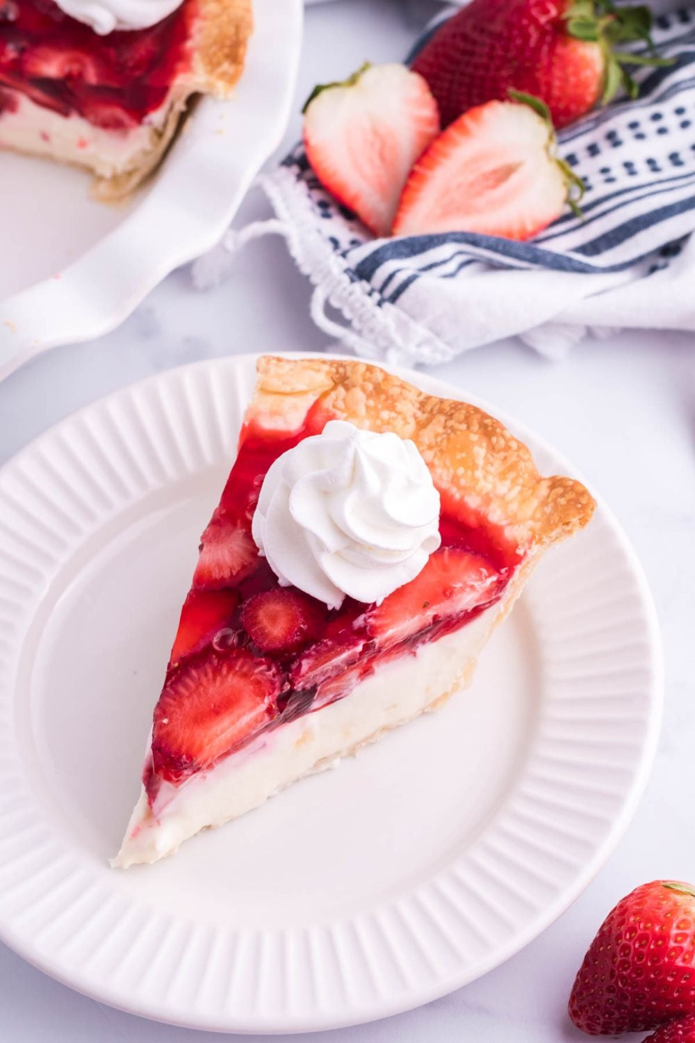 strawberry cheesecake pie sliced on plate