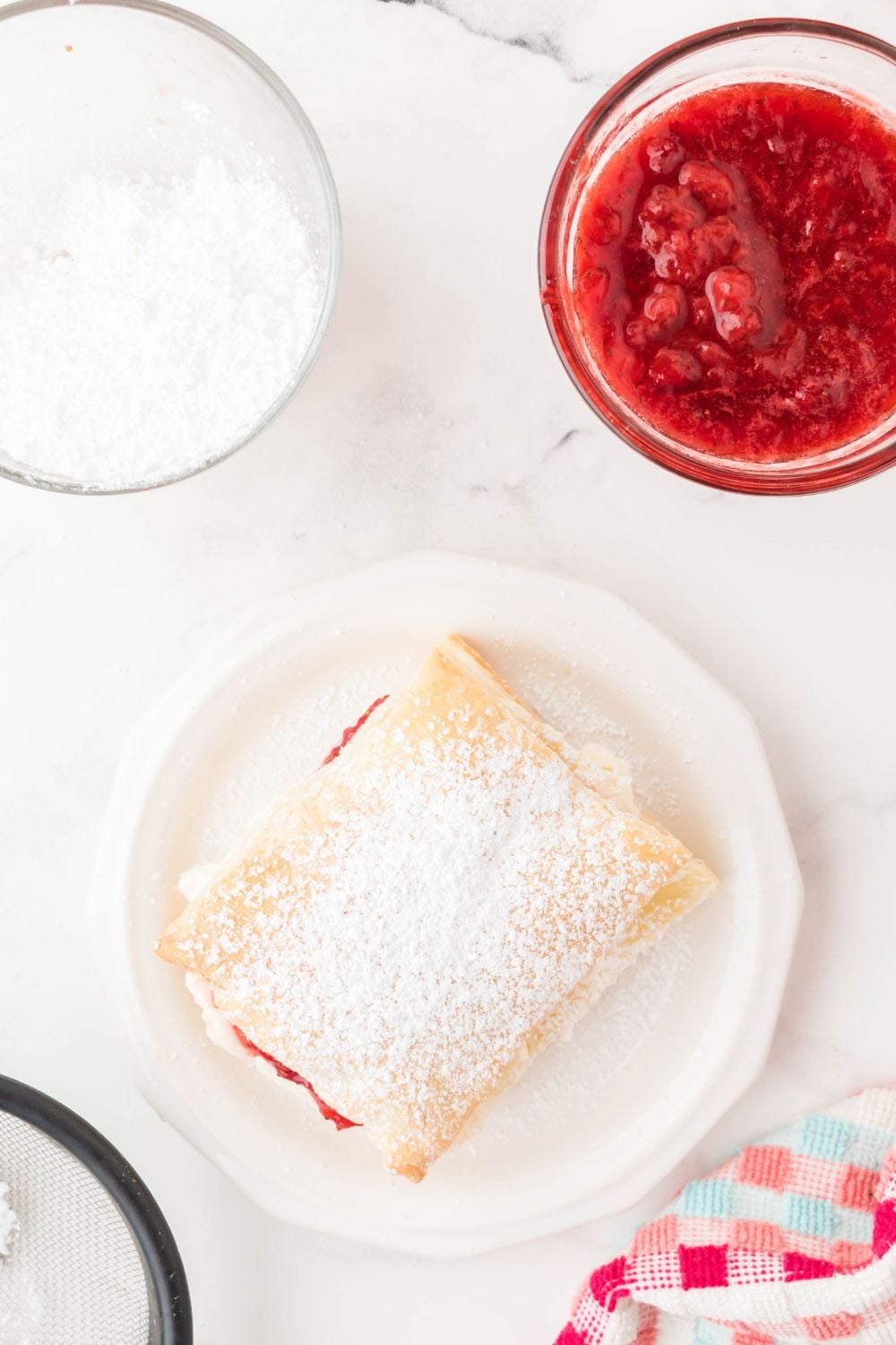 powdered sugar strawberry puff pastry on plate