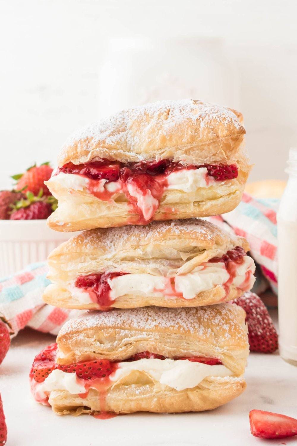 puff pastries stacked on top of each other with berries around it