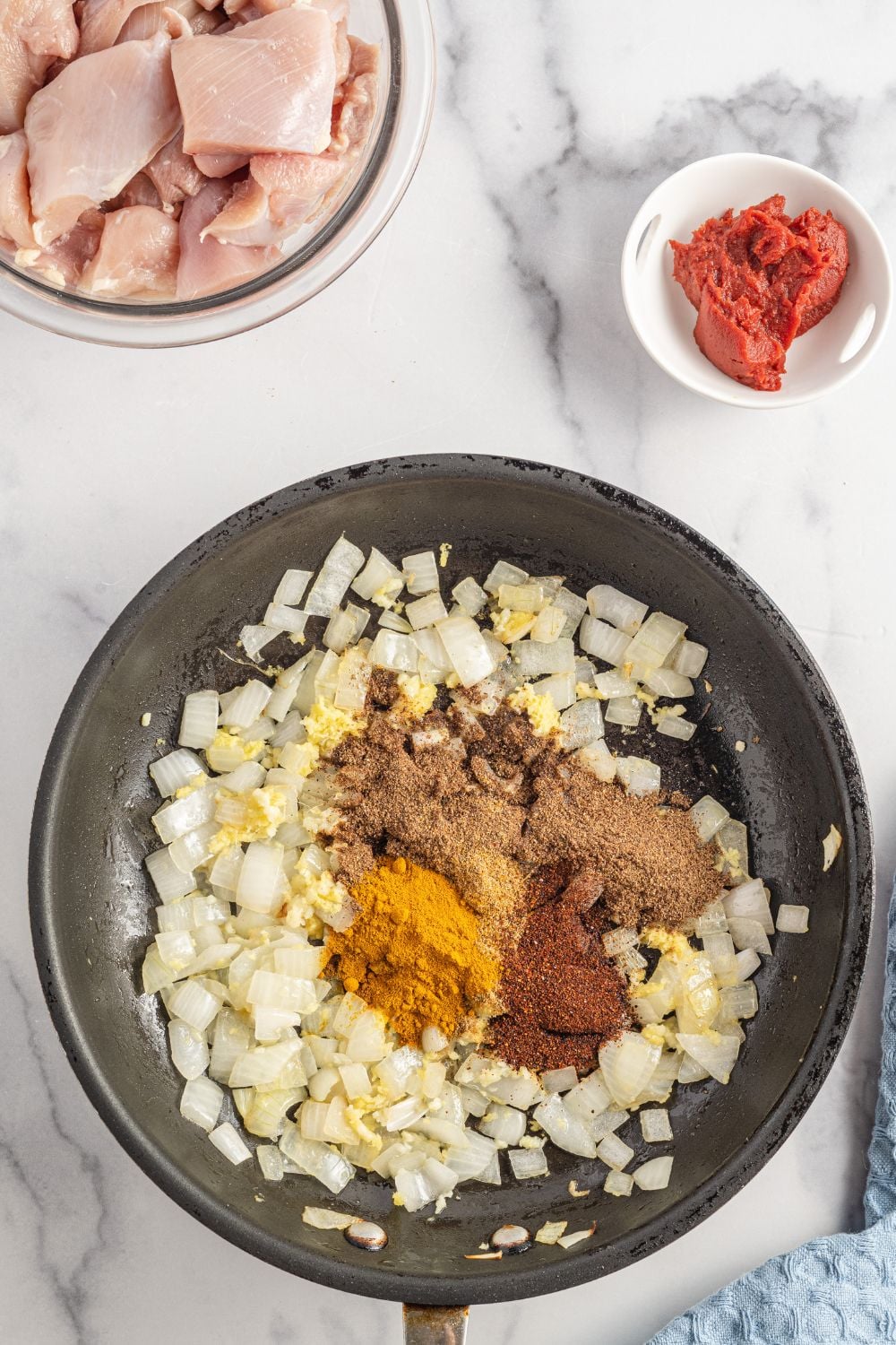spices on top of onions on pan