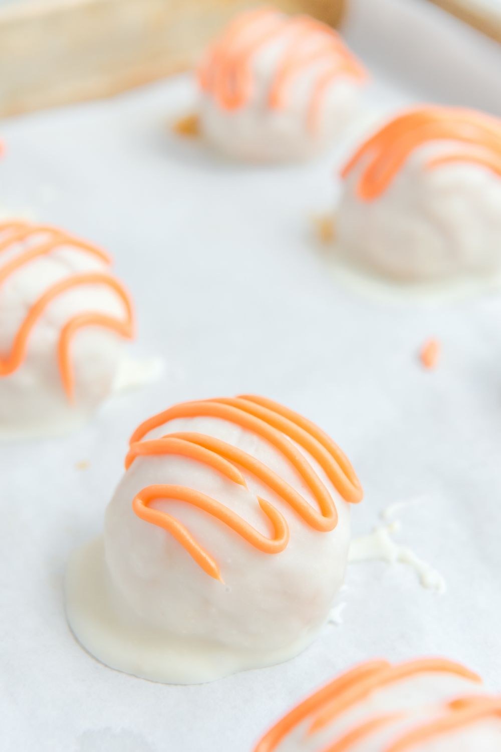White Chocolate Pumpkin Truffles on parchment paper 