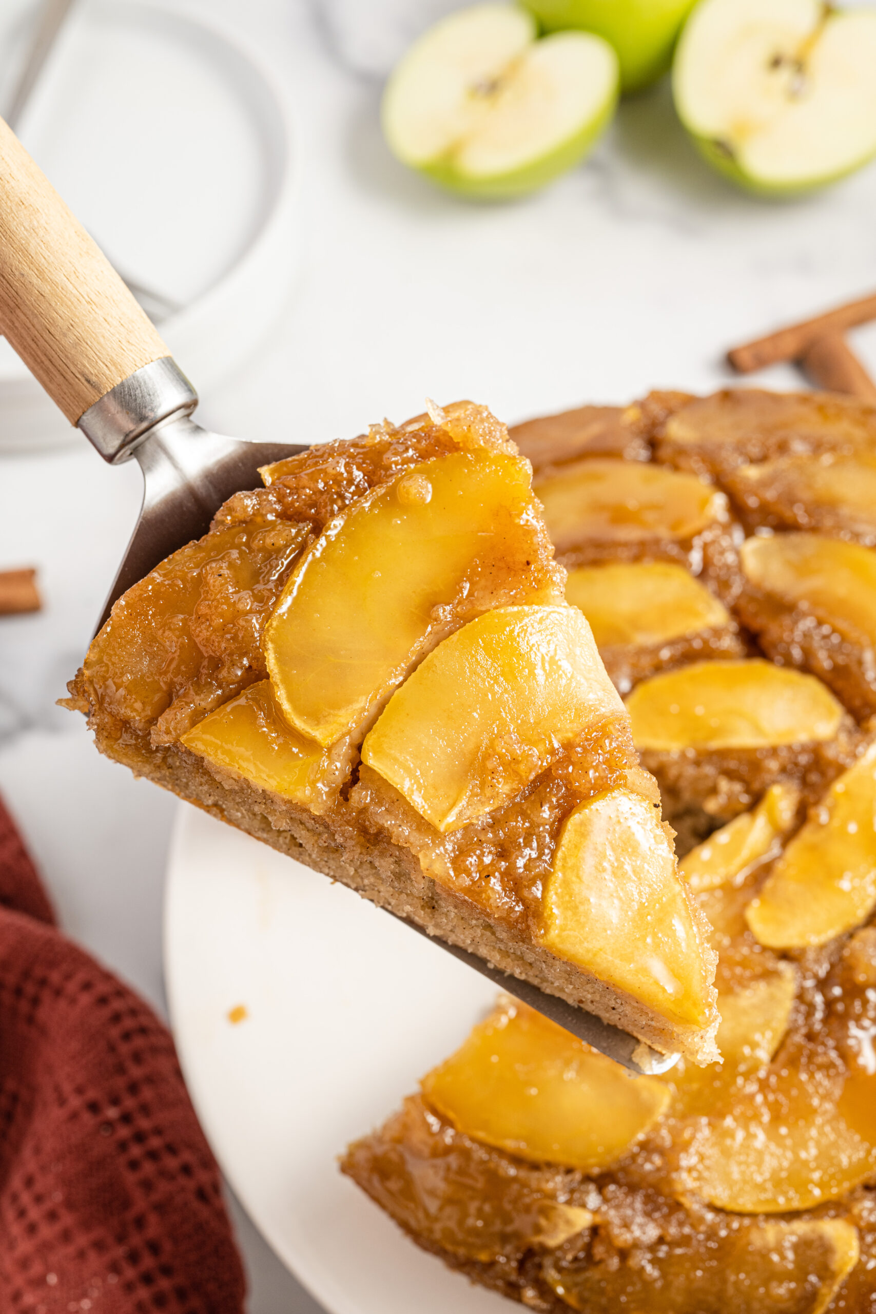 upside down apple cake on a spatula