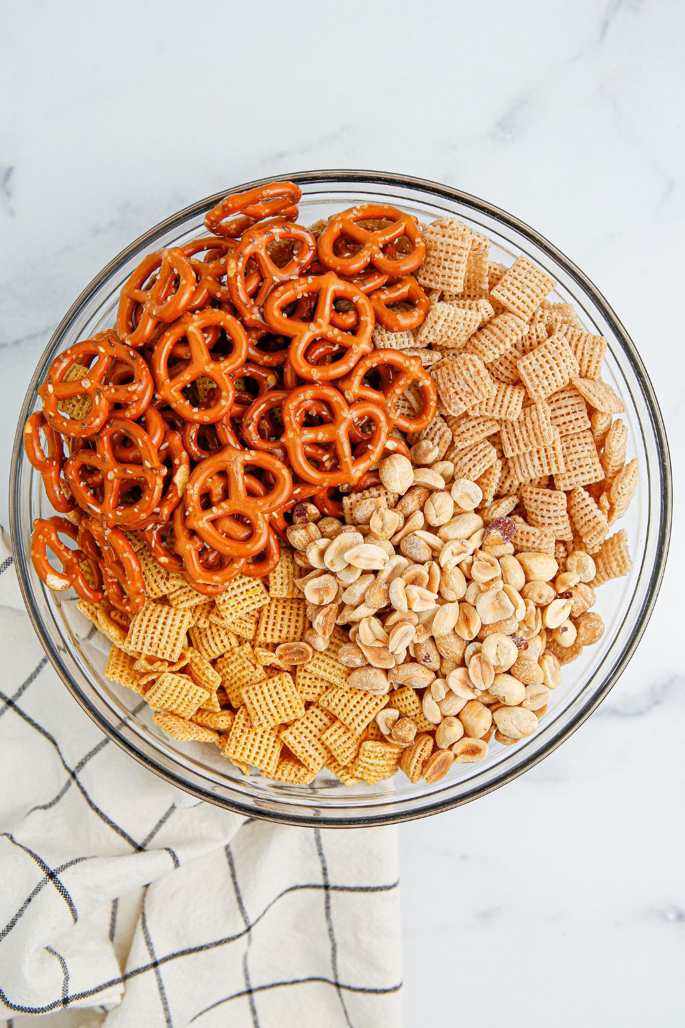 ingredients for snack mix in glass bowl