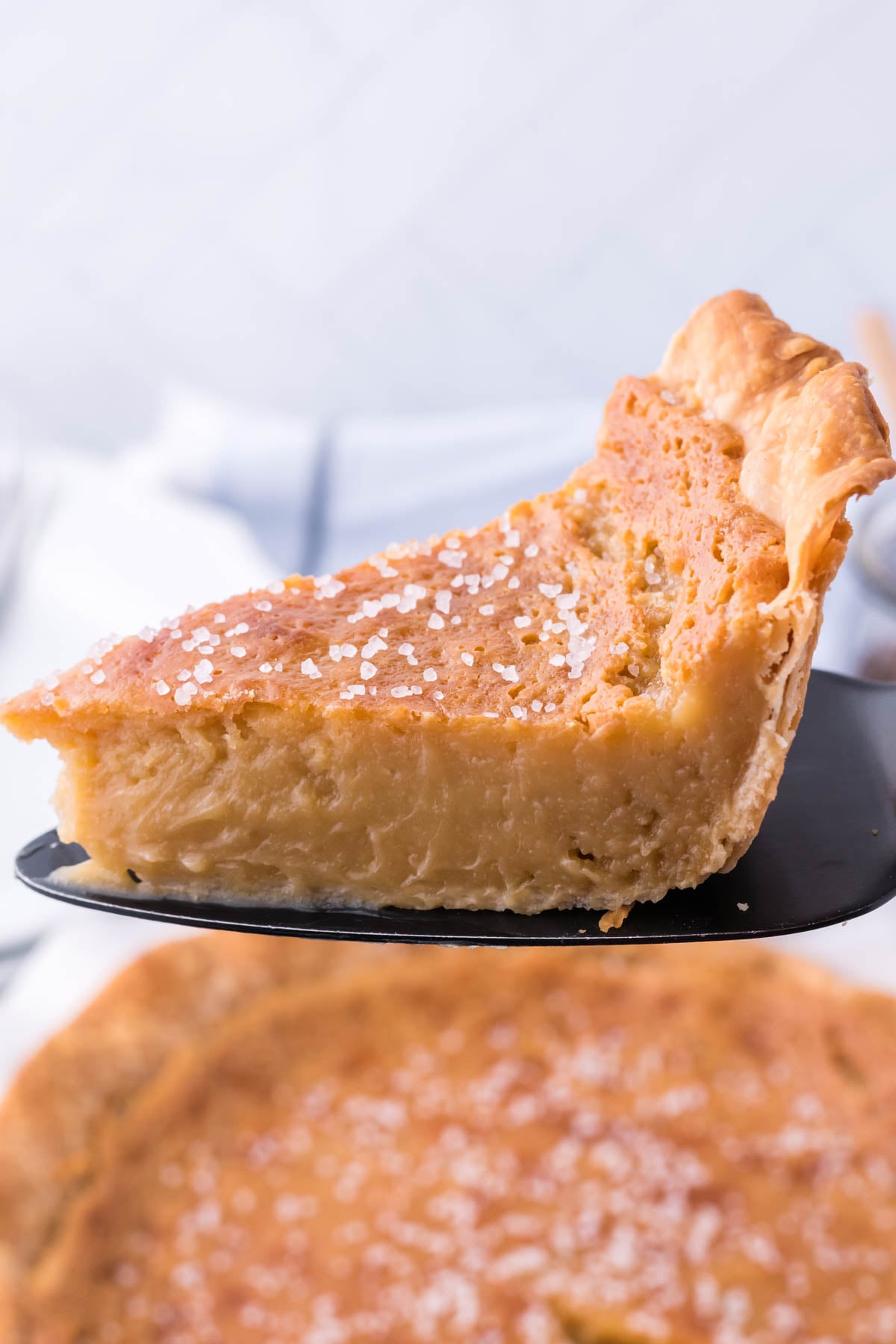 Honey Pie slice being lifted up on a black pie server