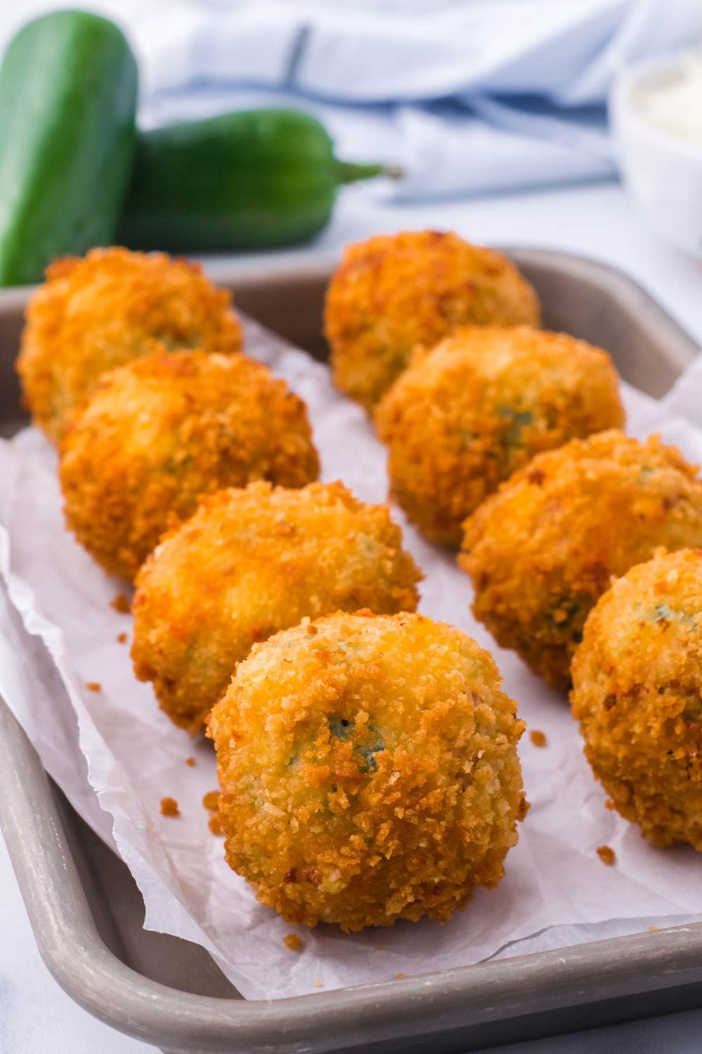 Jalapeno Popper Bites on a baking stray with parchment paper on it