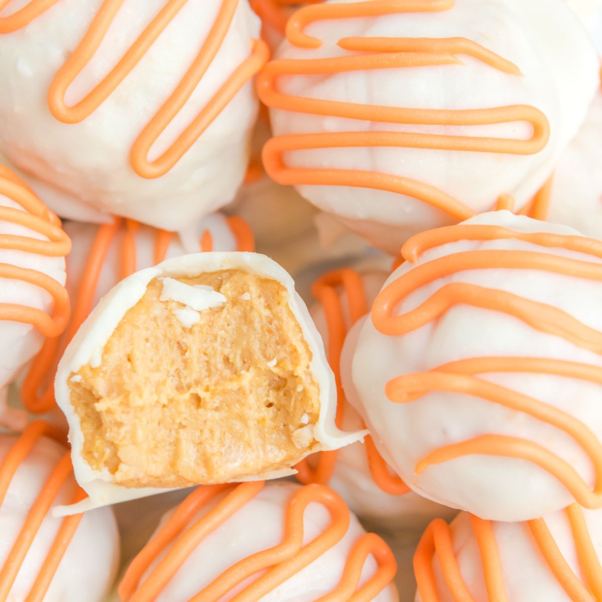 White Chocolate Pumpkin Truffles with a bite taken out of it 