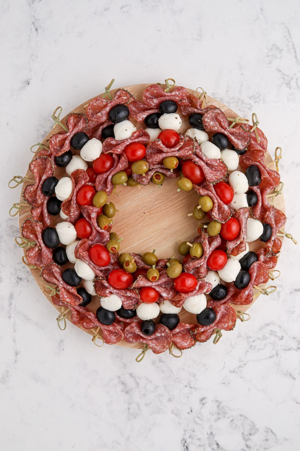 looking down at a wreath shaped appetizer on table