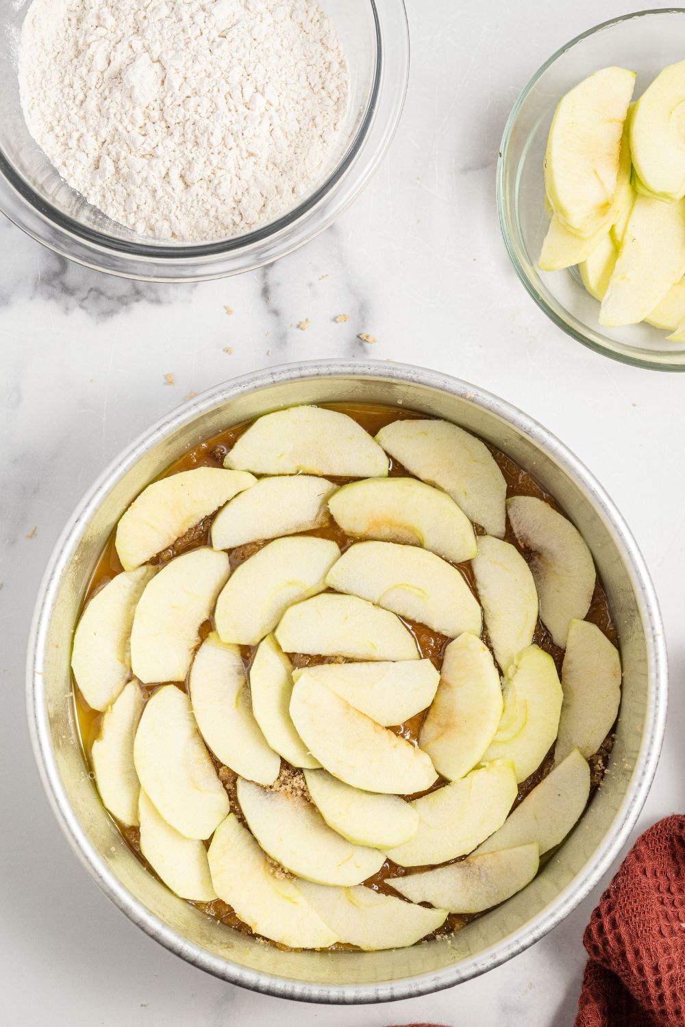 sliced apples in a cake pan on counter