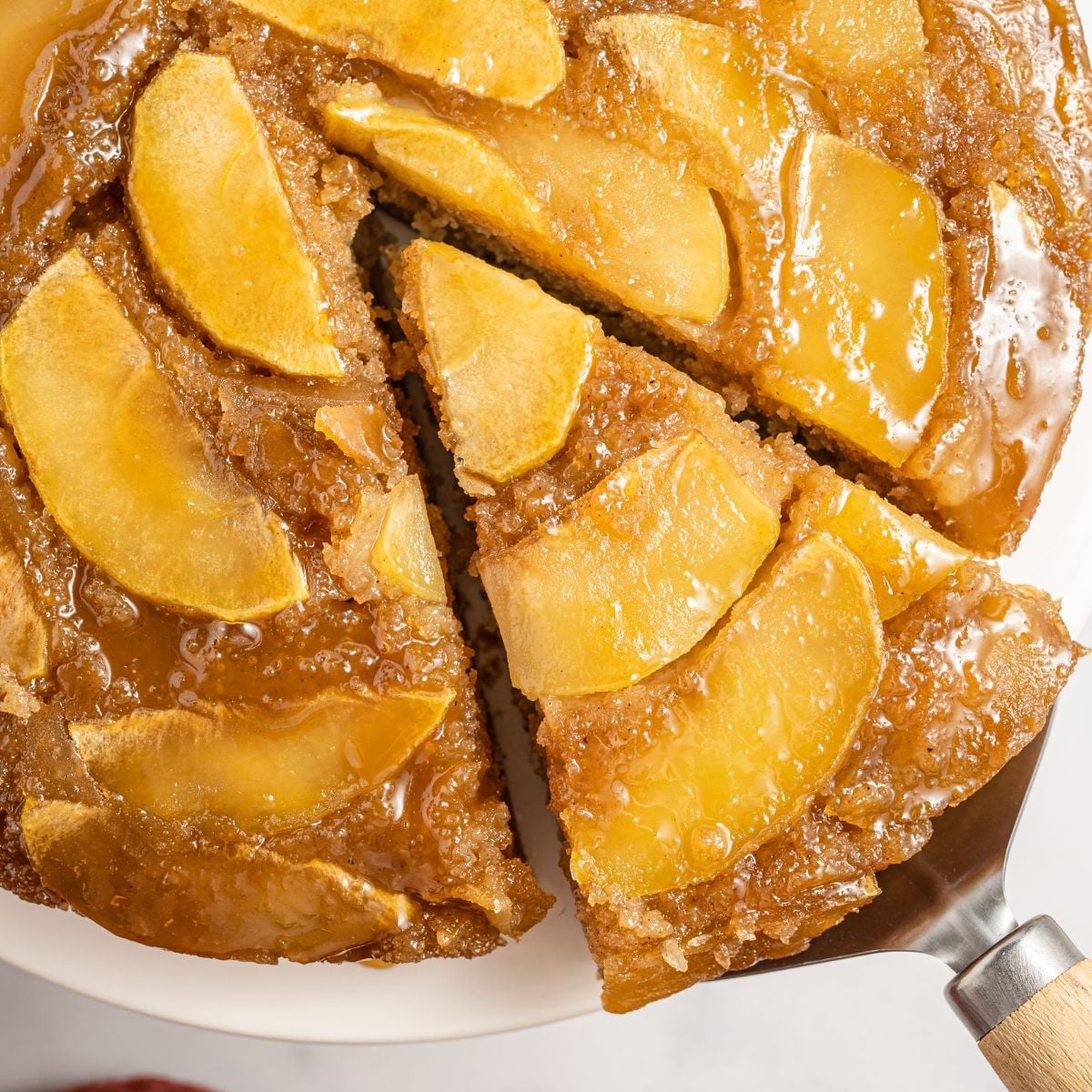 Apple Upside Down Cake with a slice being lifted up