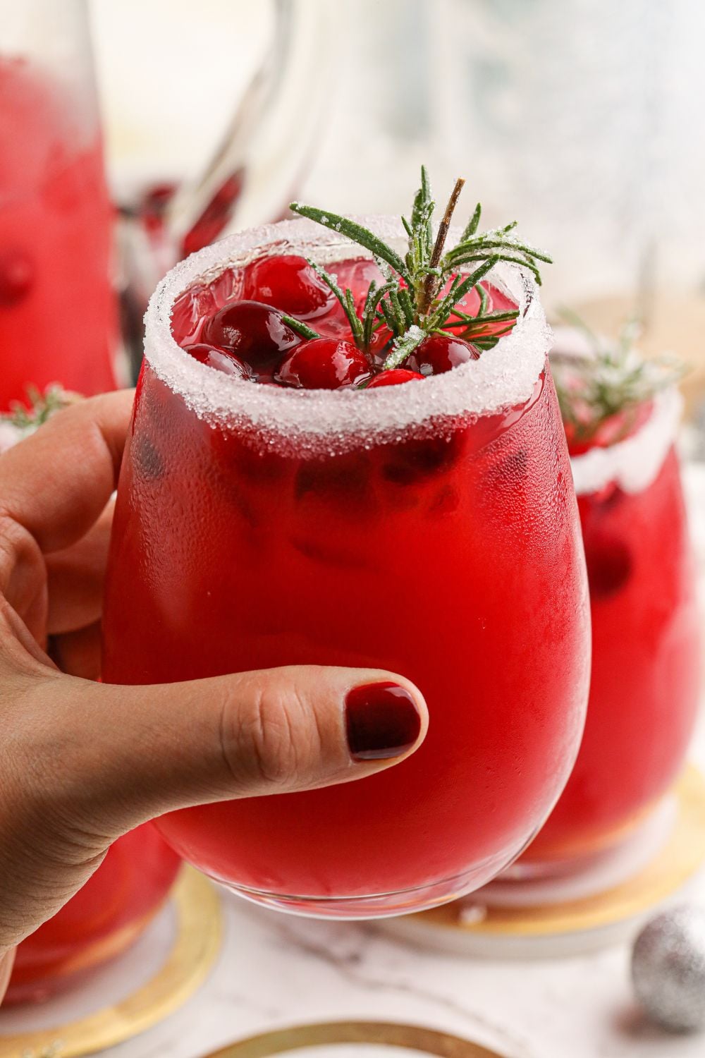 holding cocktail in hand