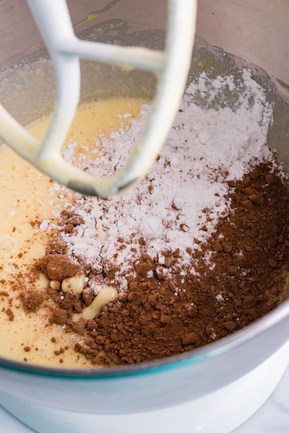 stand mixer with brownie batter ingredients in bowl