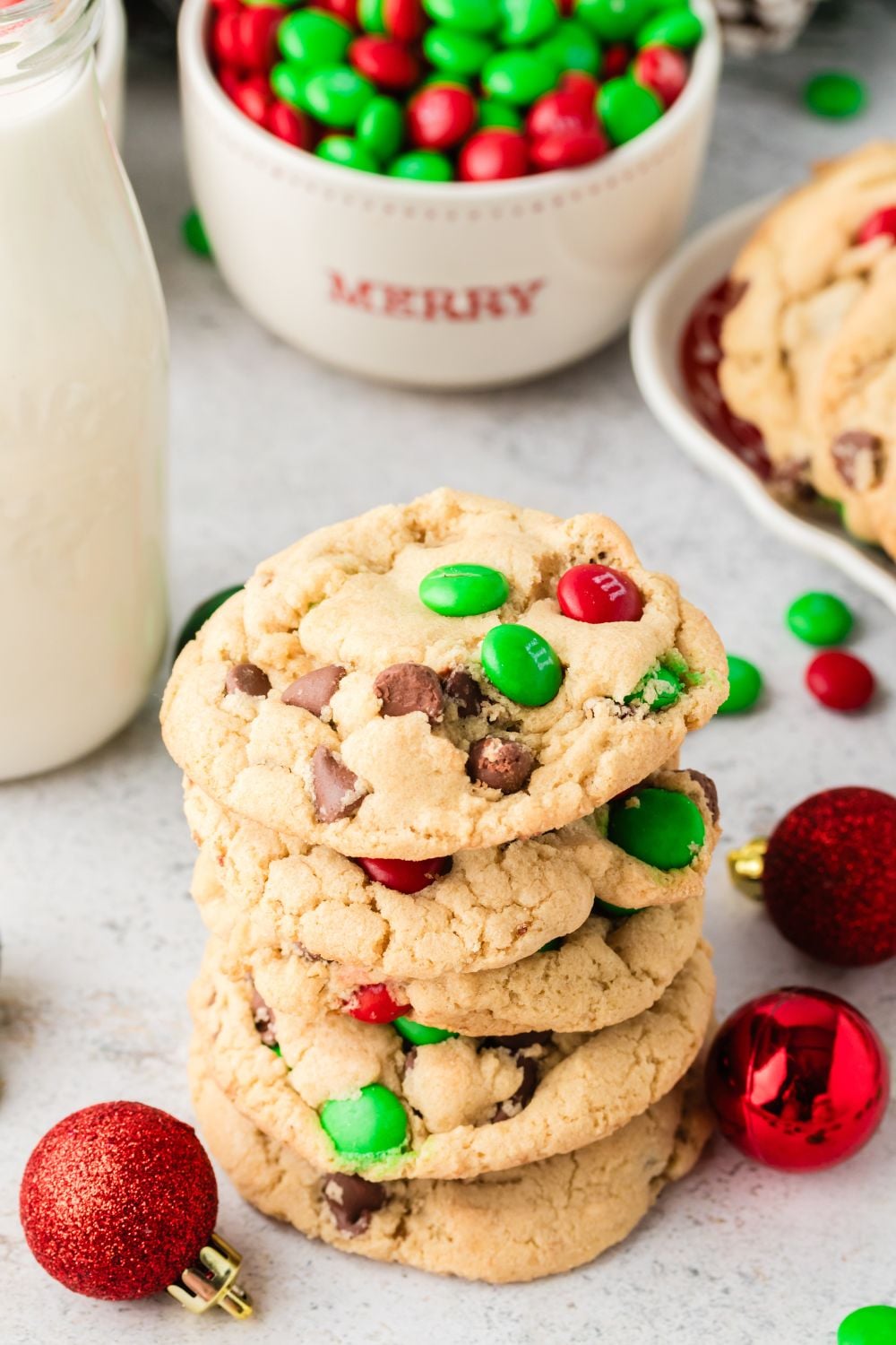 stacked cookies on table with jar of milk on side