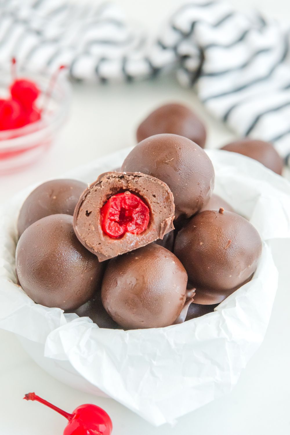brownie bites in bowl with a cherry bite showing