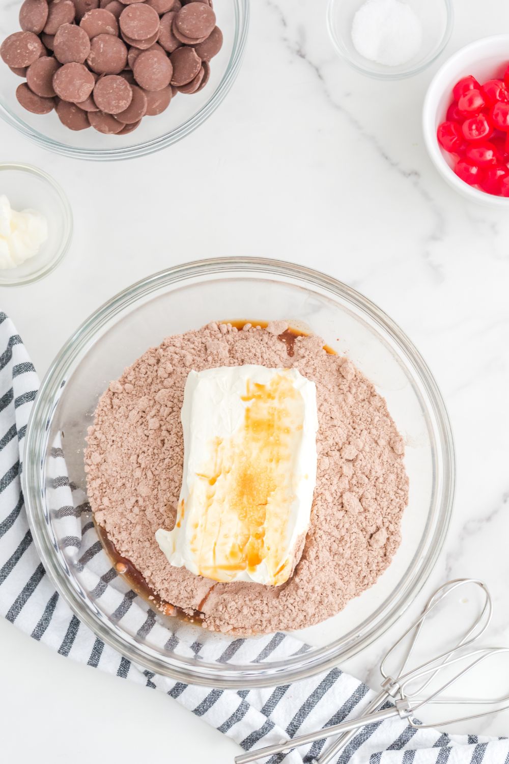 brownie batter with cream cheese and vanilla in a bowl 