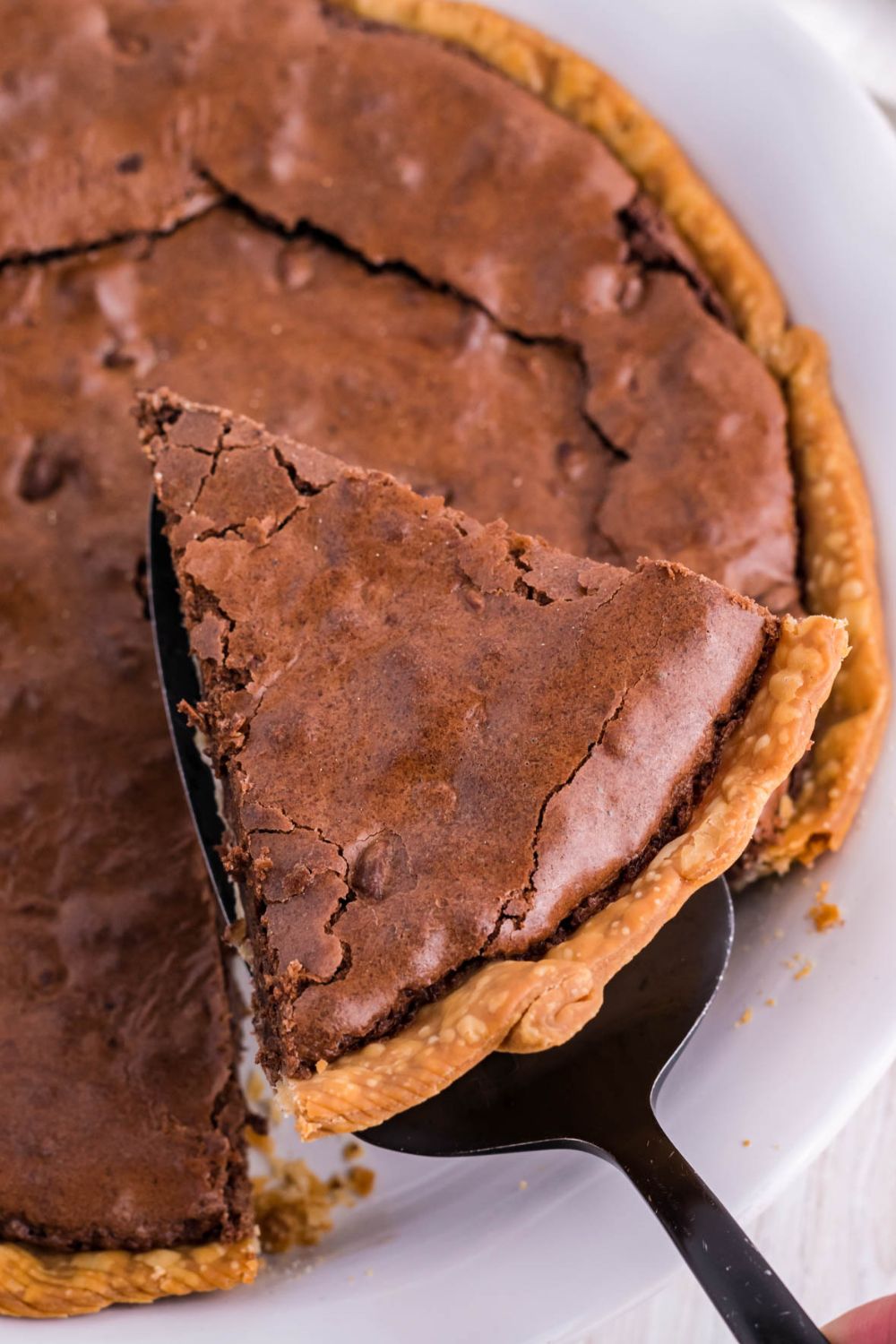 slice of brownie pie coming out of pan