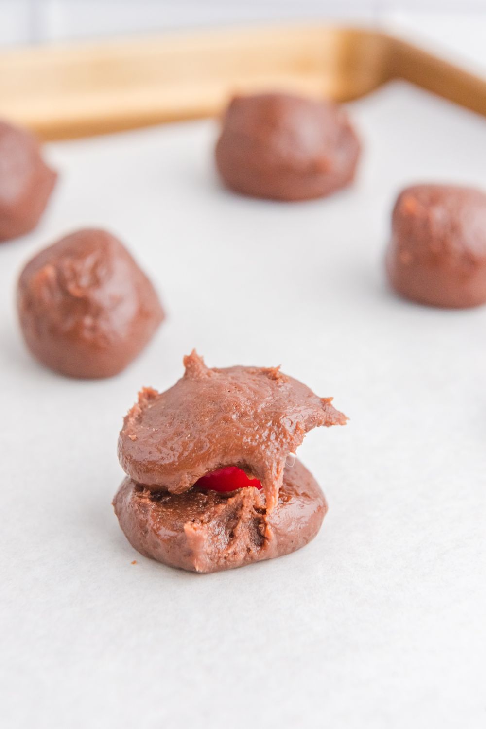 brownie batter with a cherry in center of ball 