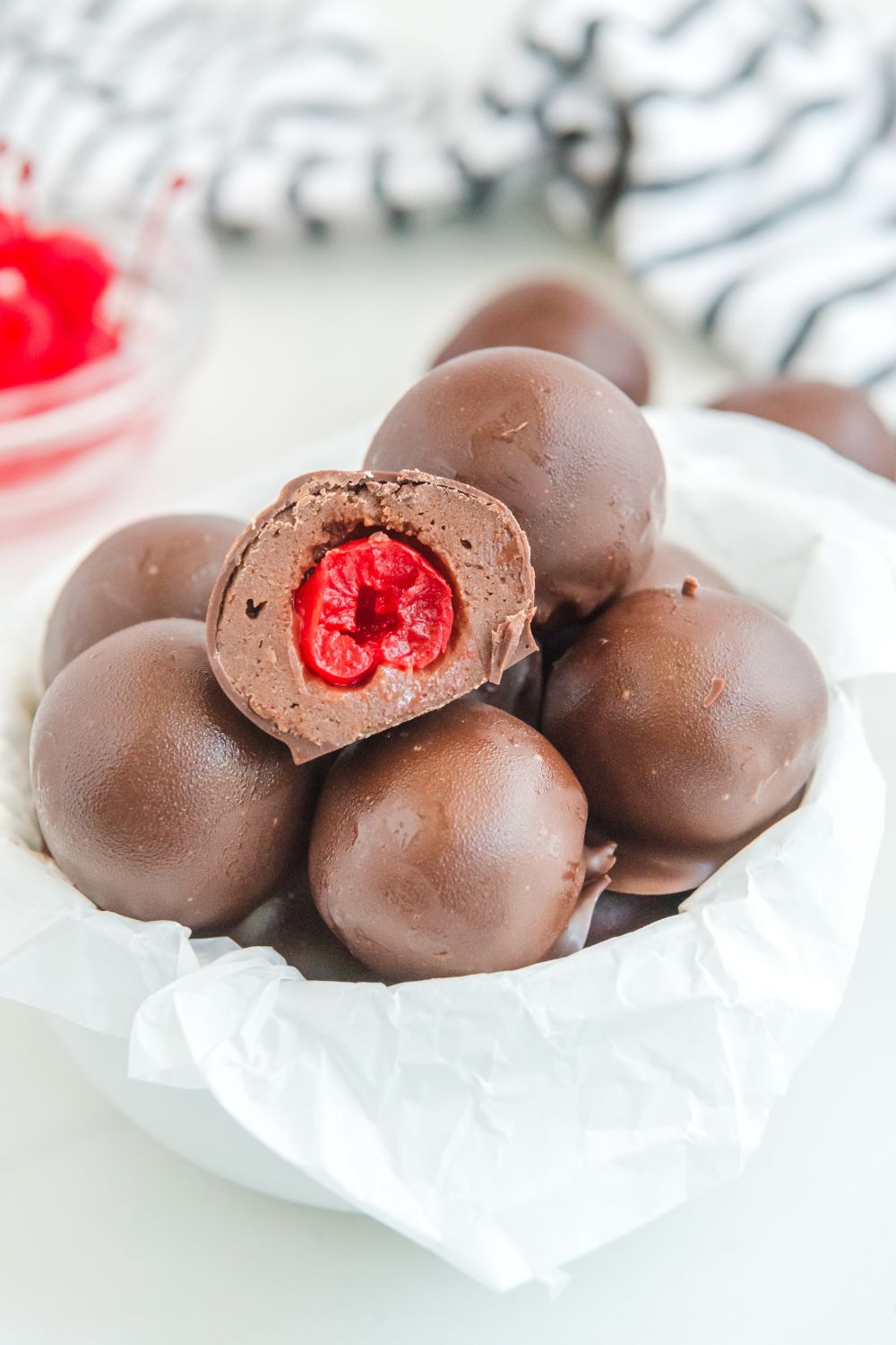 Cherry Brownie Bombs in bowl with one cut in half to show cherry center 