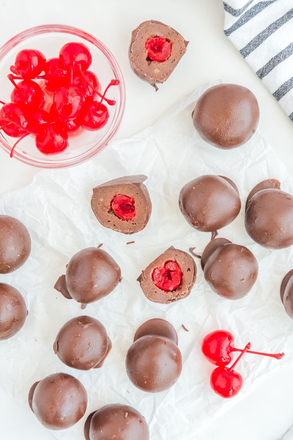 Cherry Brownie Bombs on table with bowl of cherries on side
