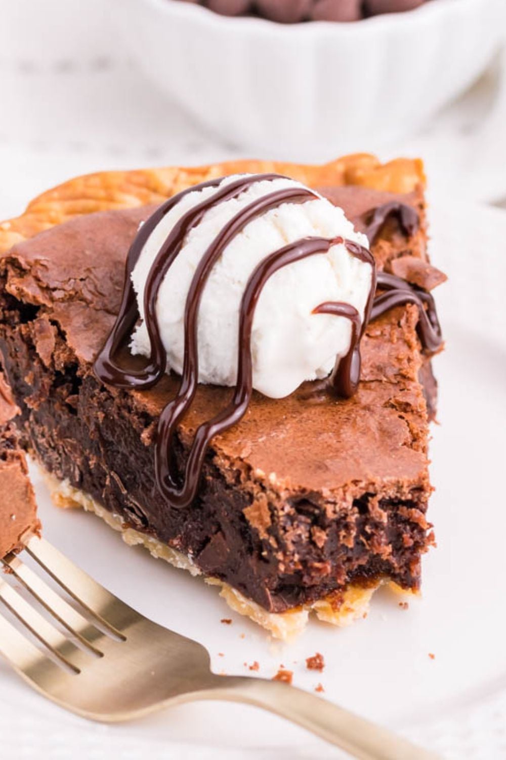 slice of chocolate pie on plate with ice cream on top