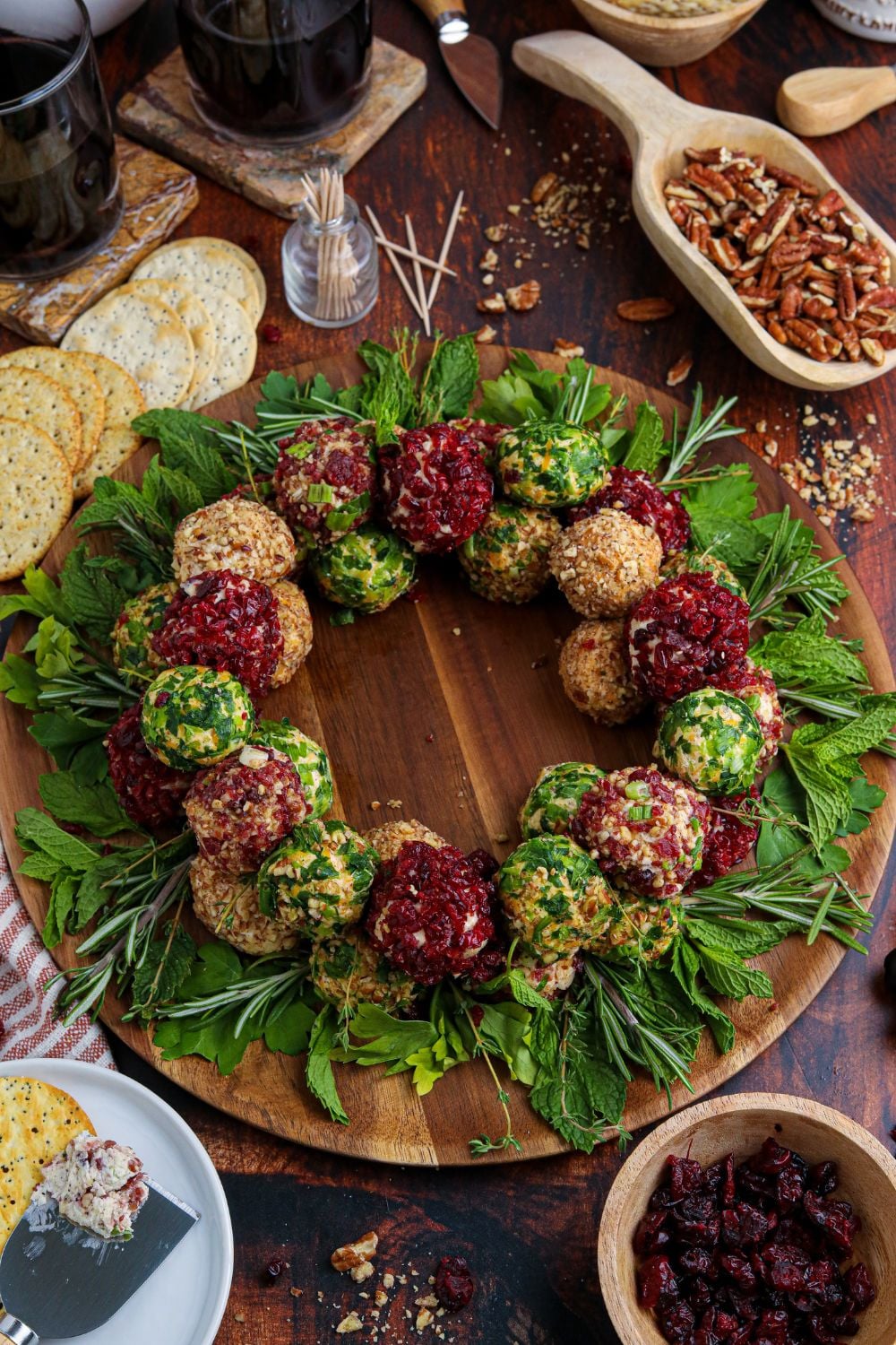 christmas cheeseballs on round cutting board