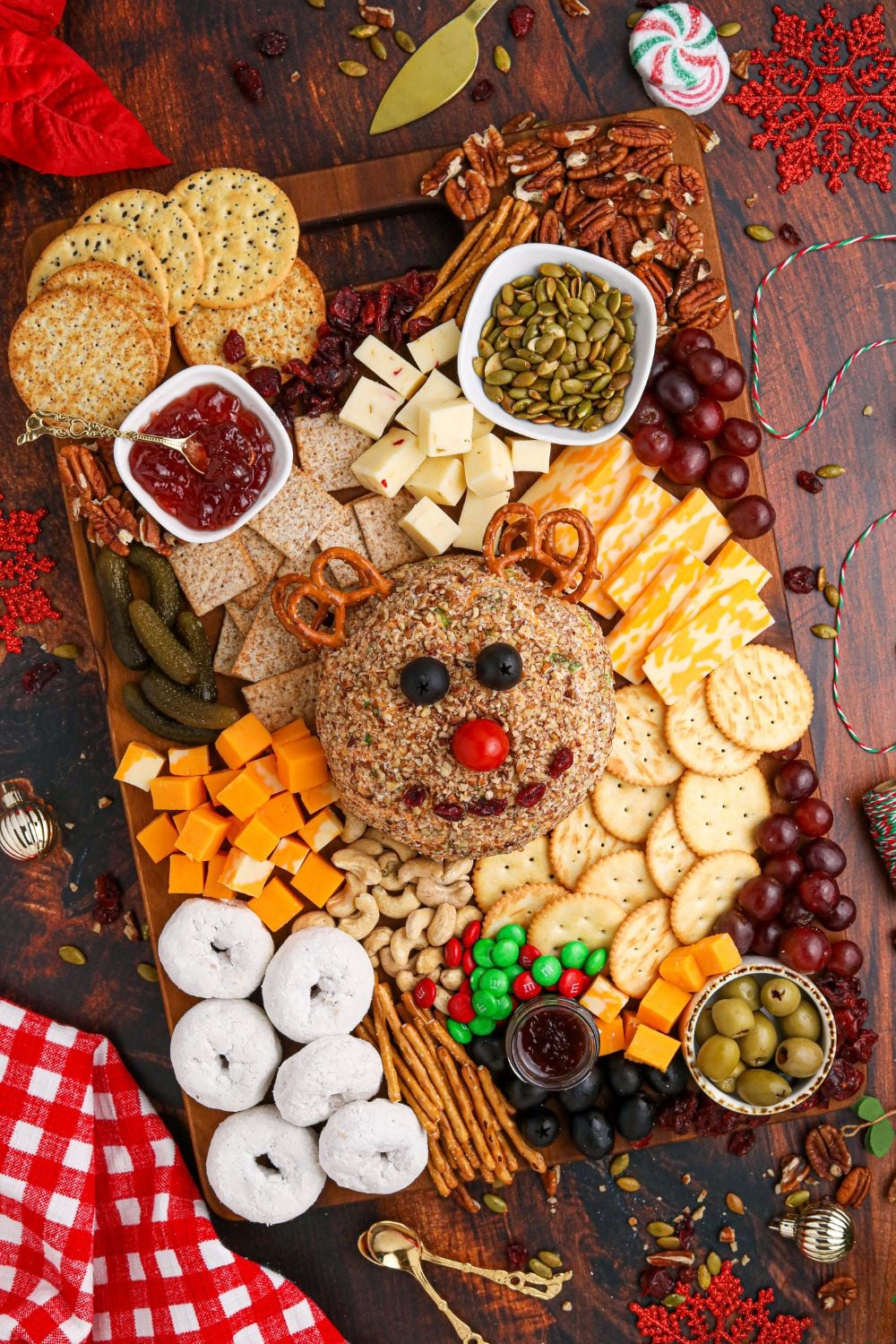 cheeseball on table with snack items around the board