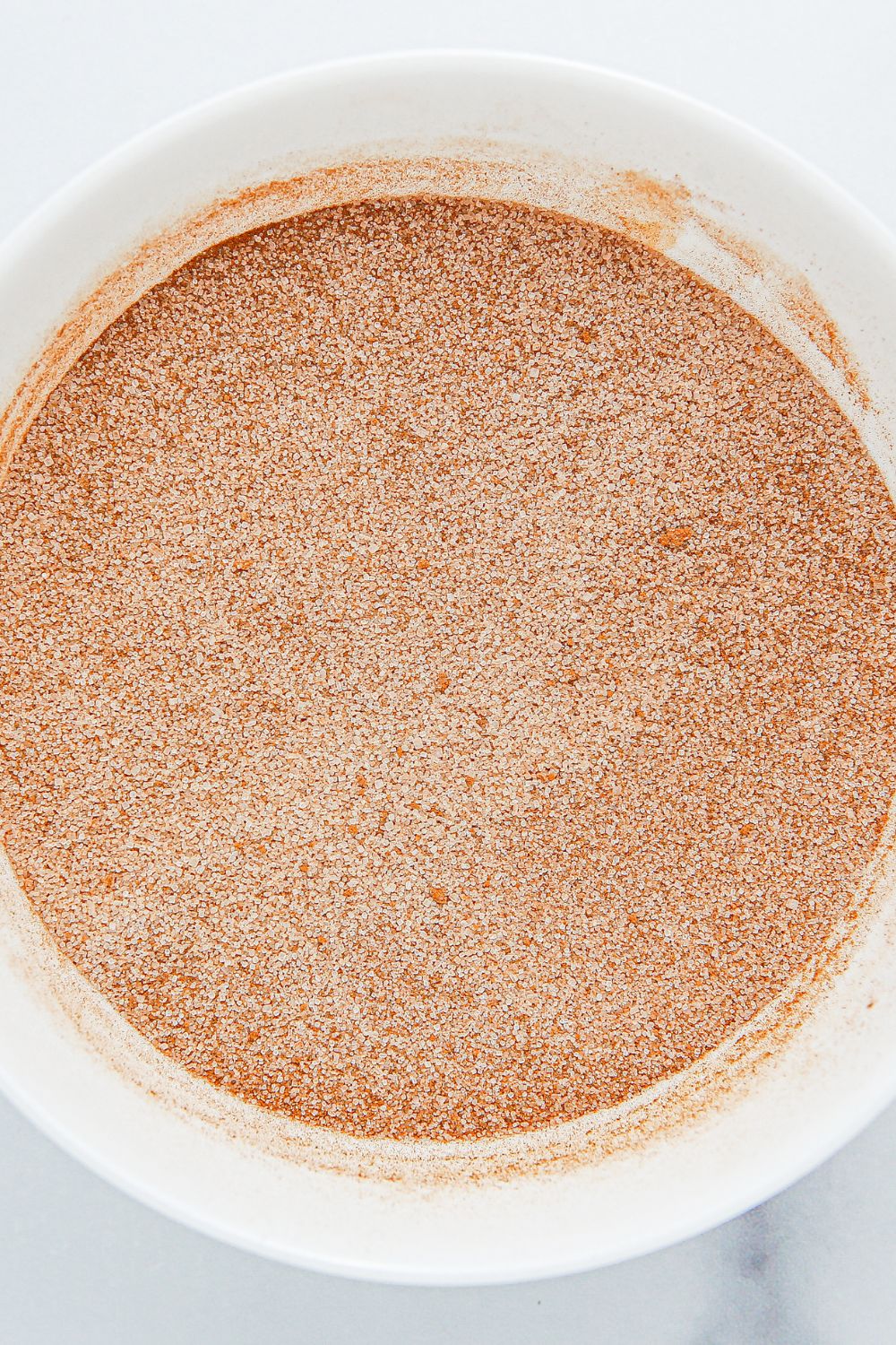 cinnamon and sugar mixture in a glass bowl