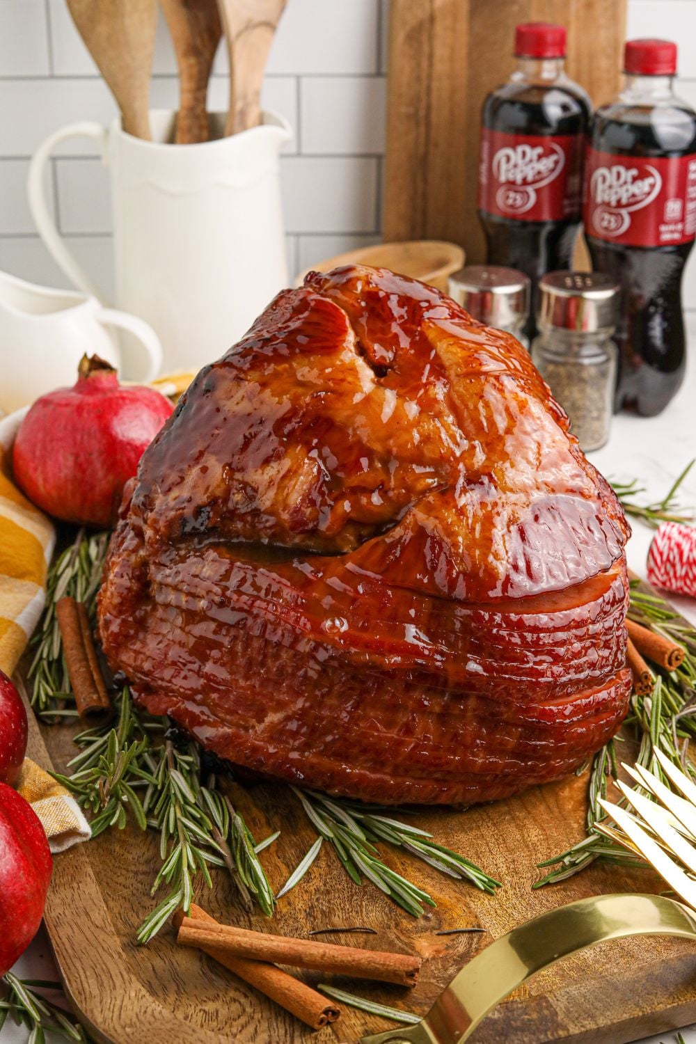 cooked and glazed ham on table with bottles of dr pepper behind it on table