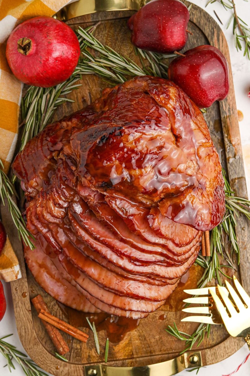 Dr. Pepper Ham side overhead view of it on a serving tray with pomemegranate and apple on side