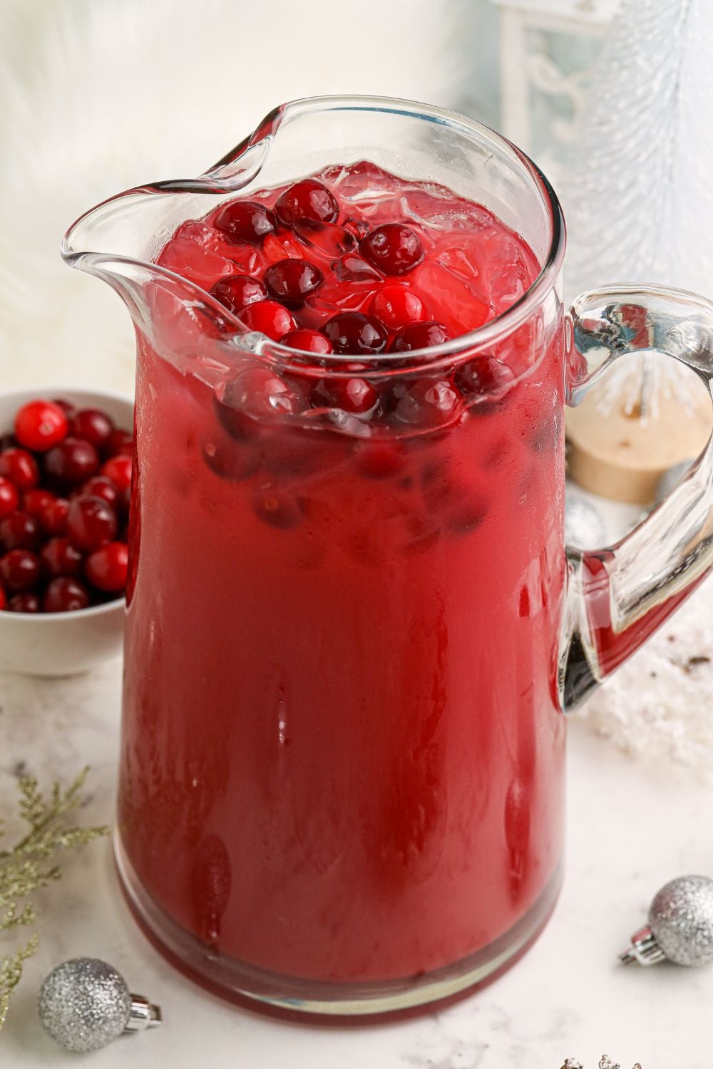 Mistletoe Margarita in a pitcher with cranberries on top 