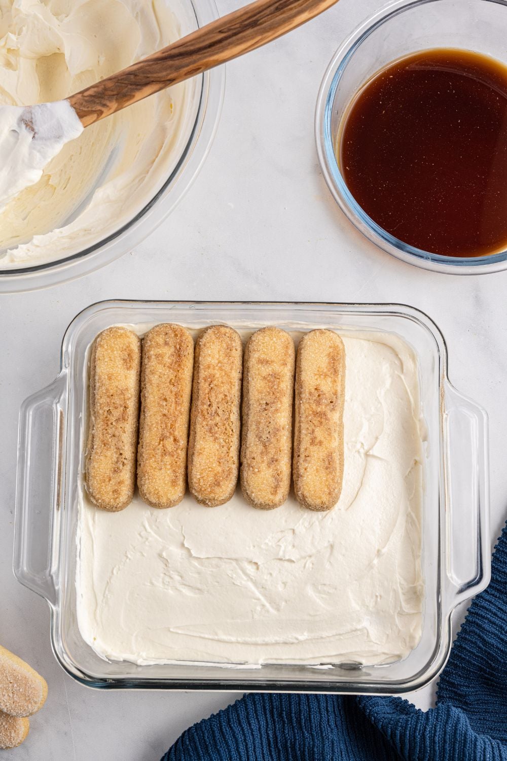 laying lady fingers in pan for laying tiramisu