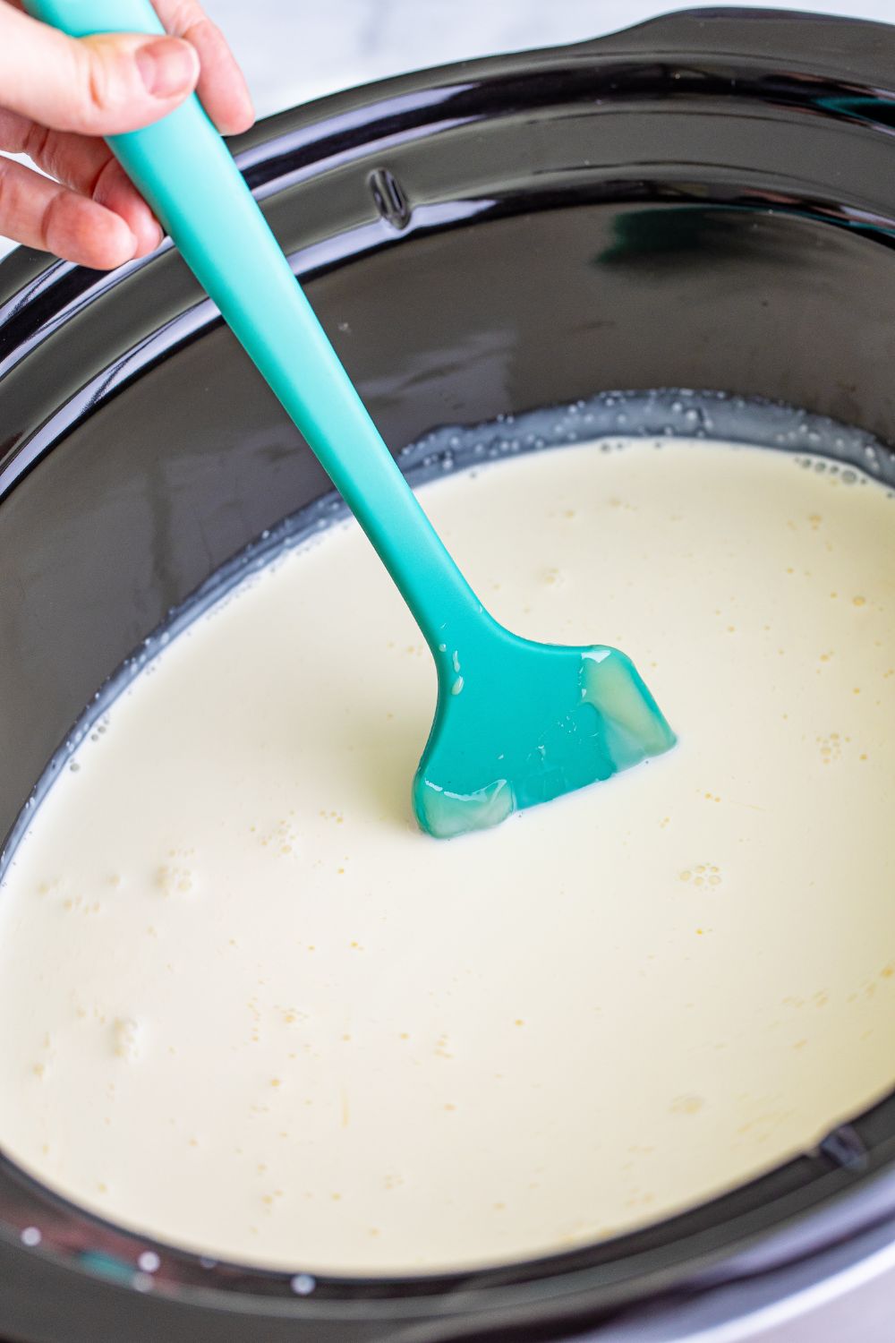 stirring hot chocolate in slow cooker