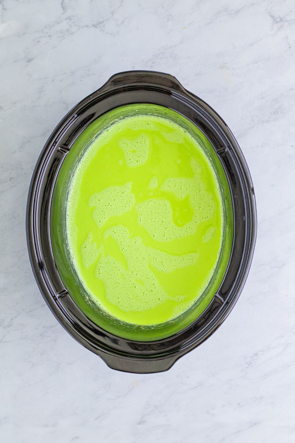 Grinch Hot Chocolate in slow cooker on table