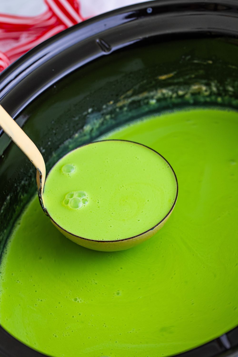 Grinch Hot Chocolate in a ladle in slow cooker