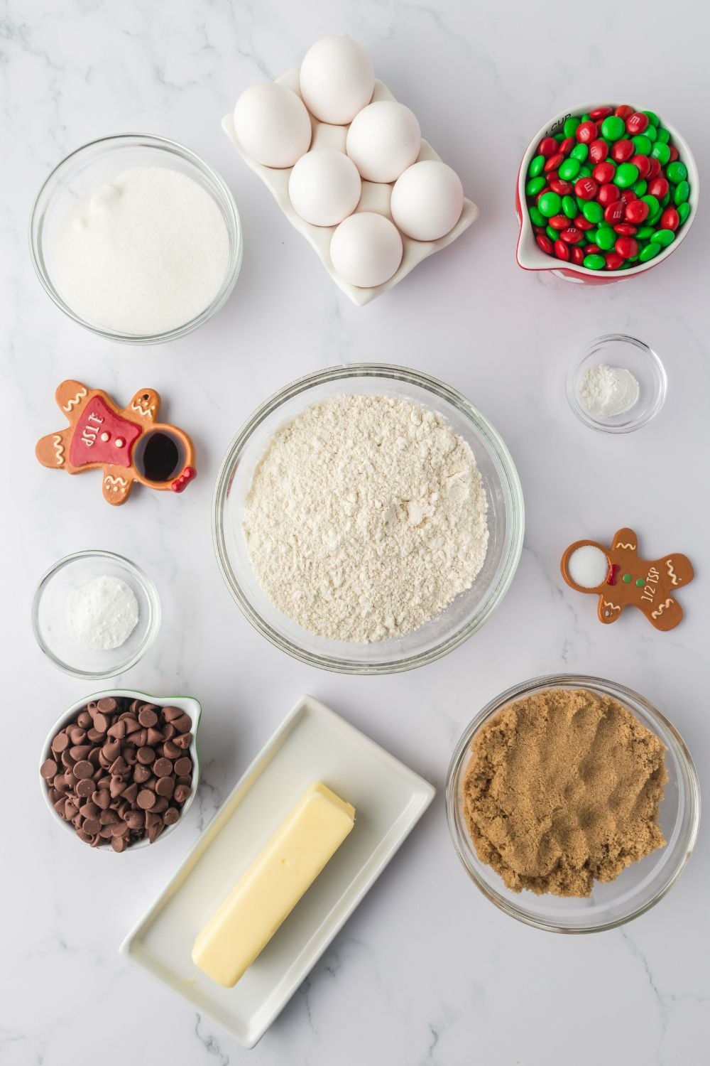 ingredients for christmas cookies in bowls on table