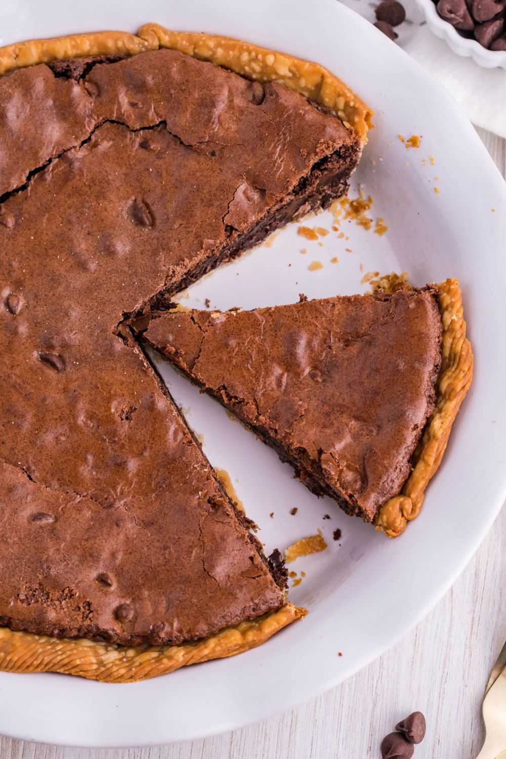 brownie pie in pan with a slice taken out of pie pan