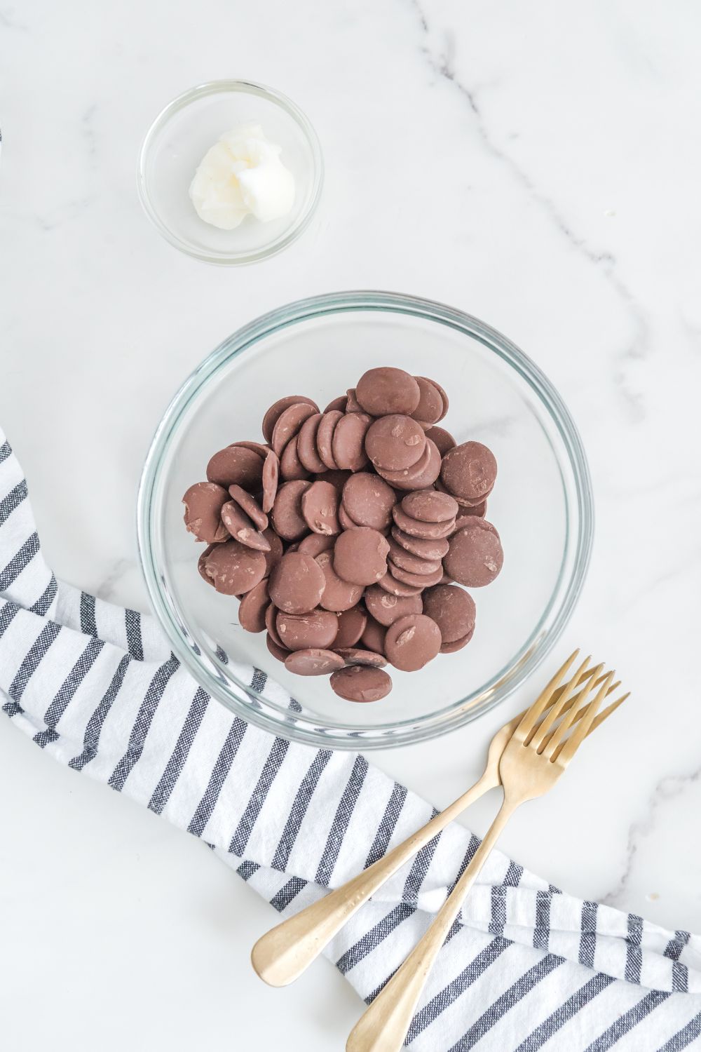 chocolate wafers in a bowl with forks on side of counter 