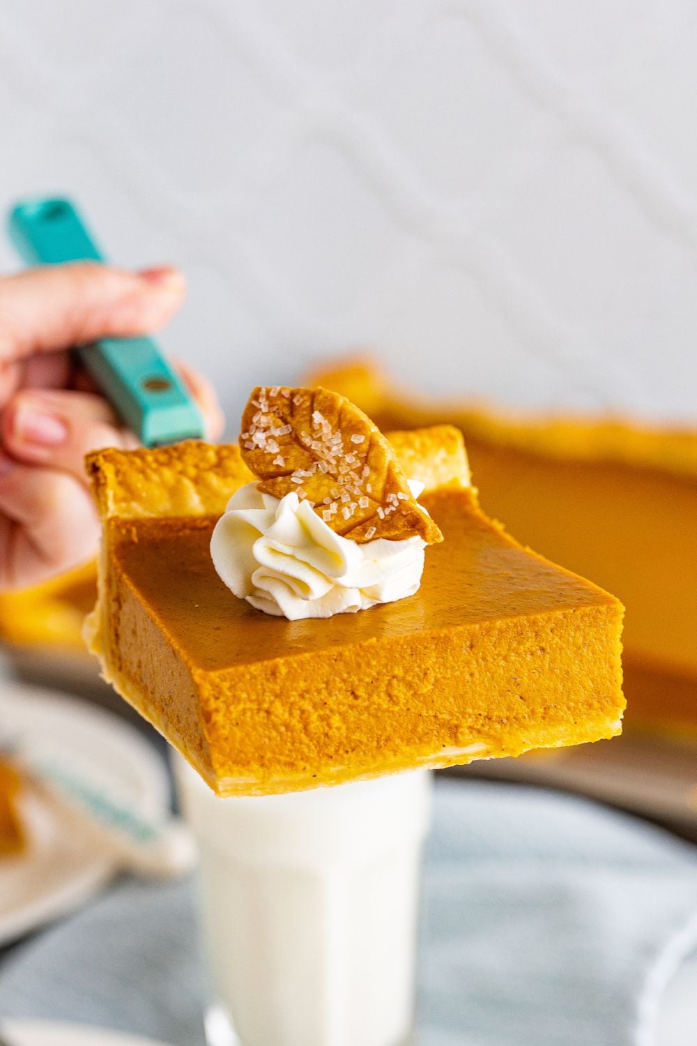 holding slice of pie on a serving spoon