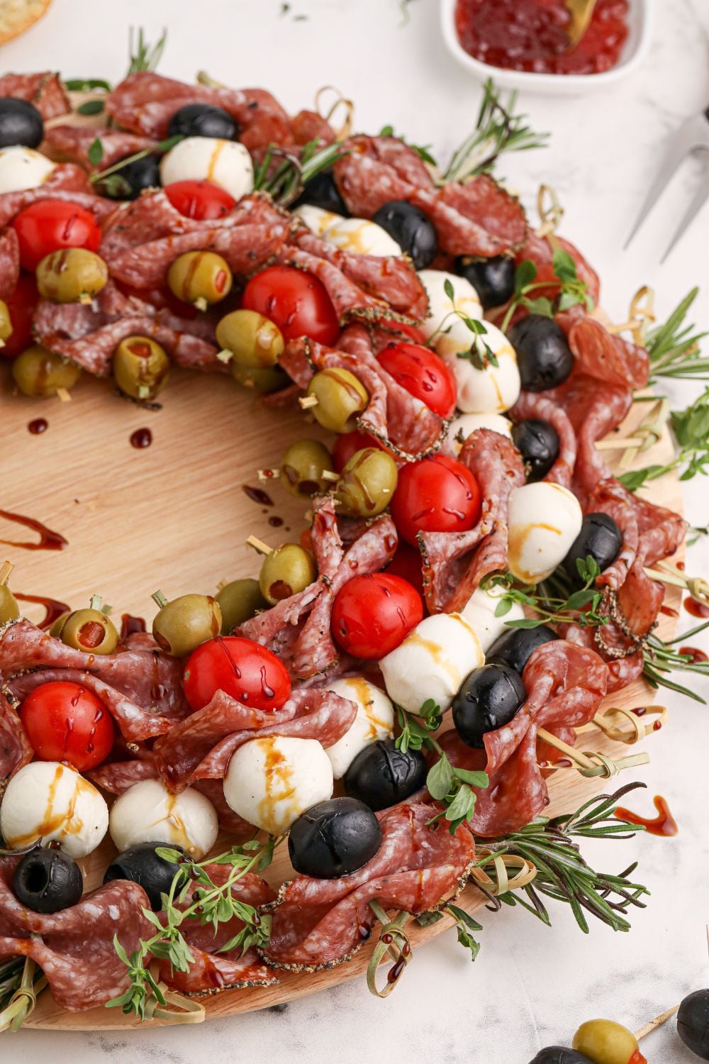 CHristmas themed appetizer of tomatoes, cheese, and meat on skewers 