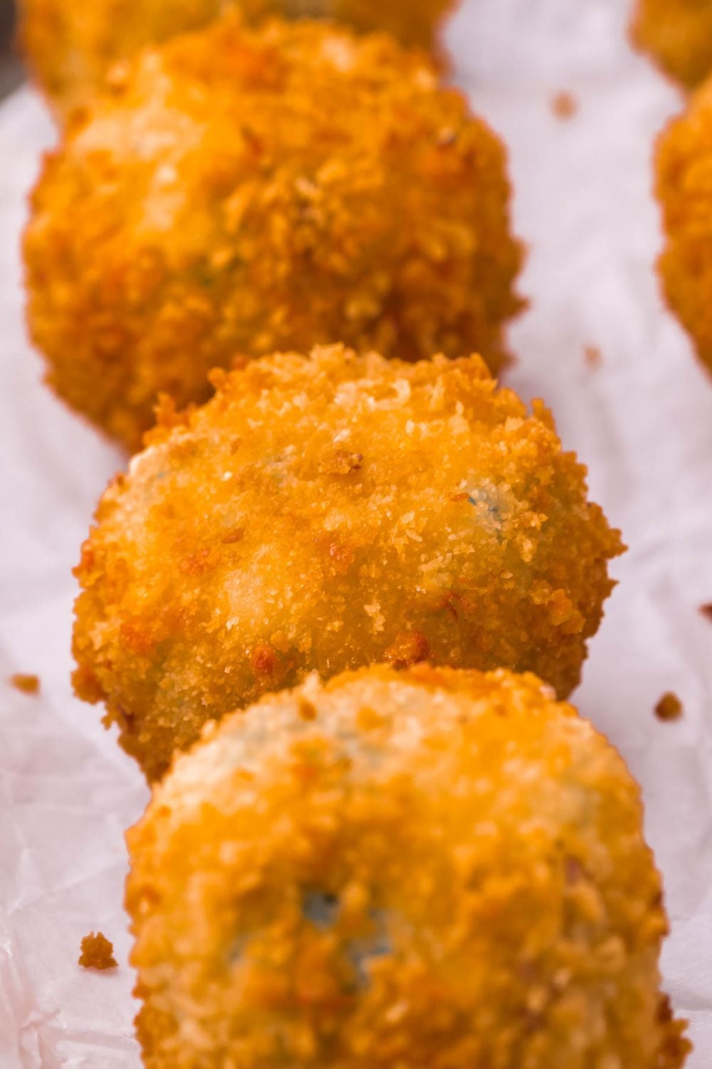 Jalapeno Popper Bites in a row on parchment paper