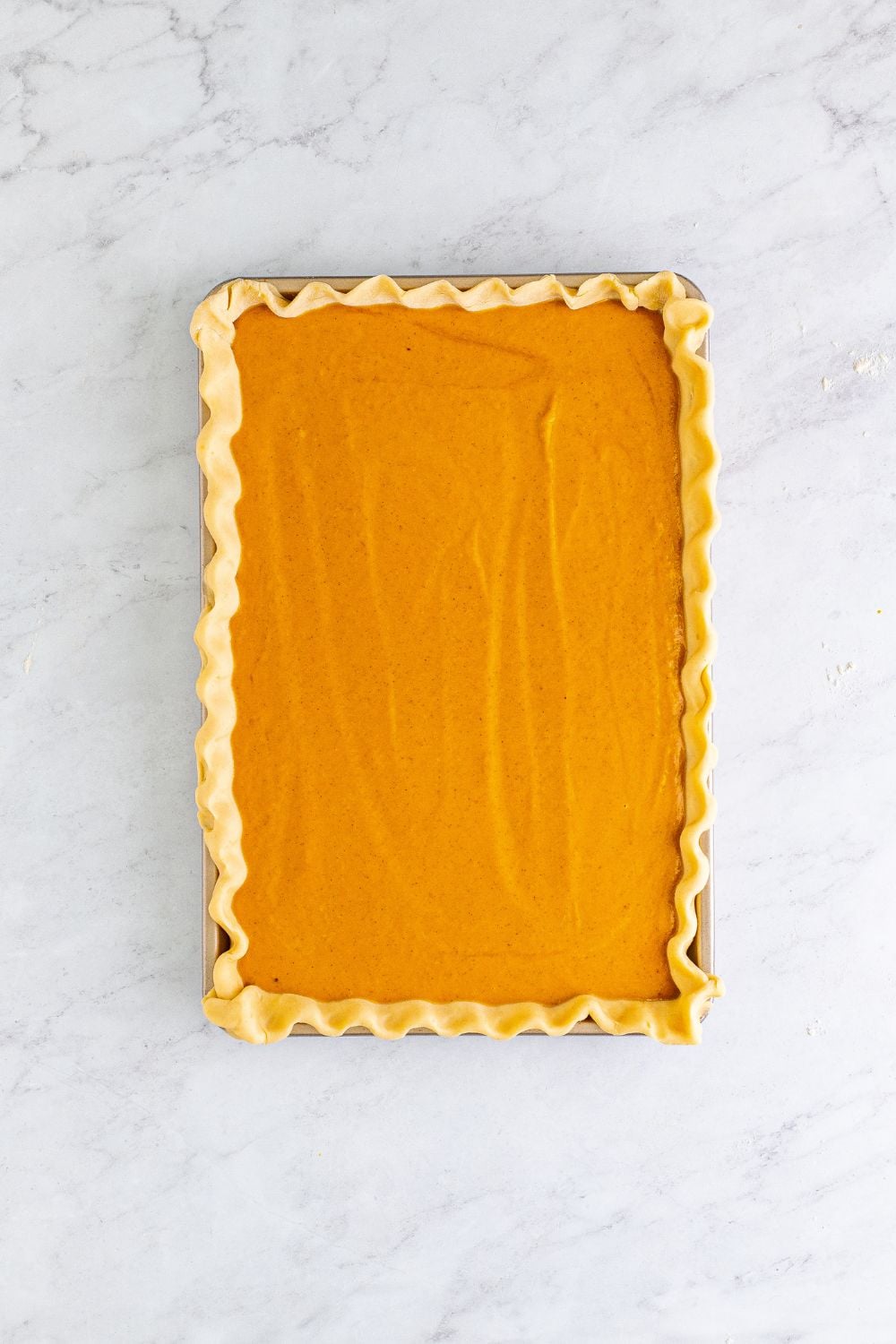 pumpkin pie filling in pie crust 