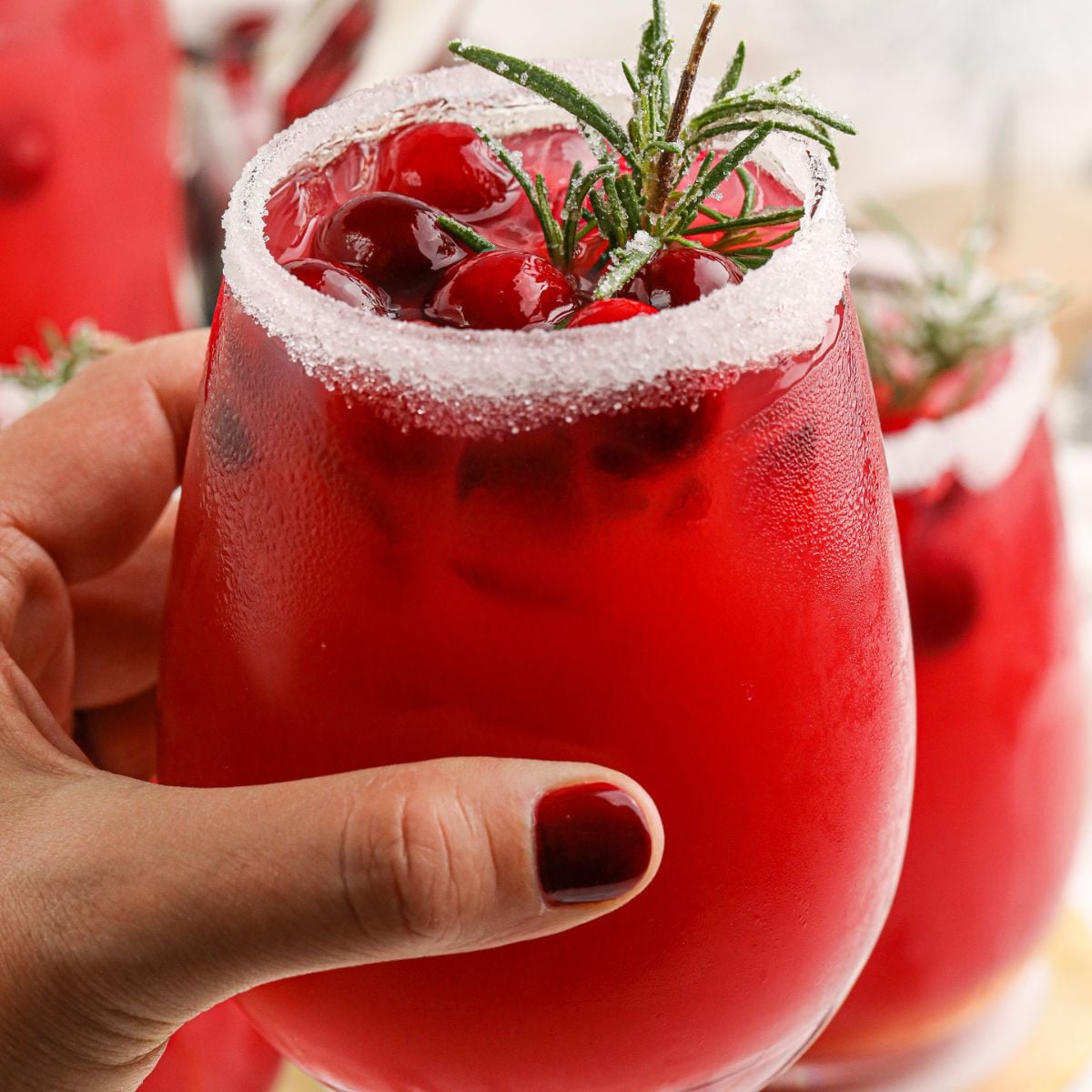 Mistletoe Margarita in glass being held in the hand