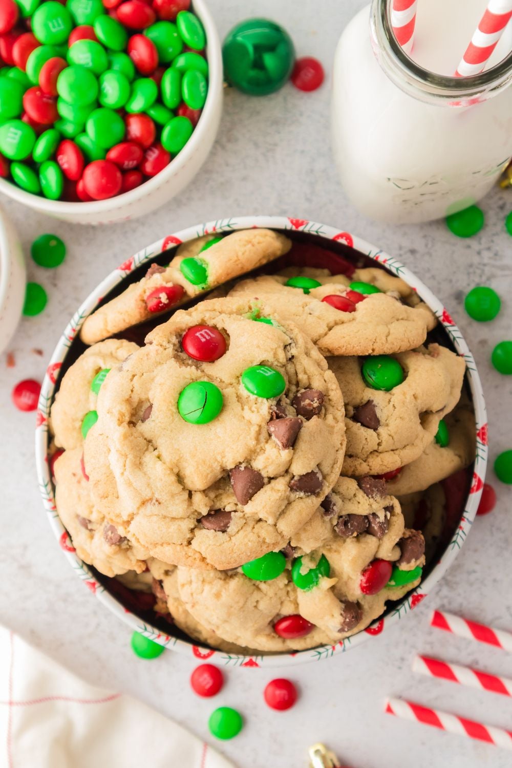 Christmas M&M Cookies in tin on table with m&ms around it